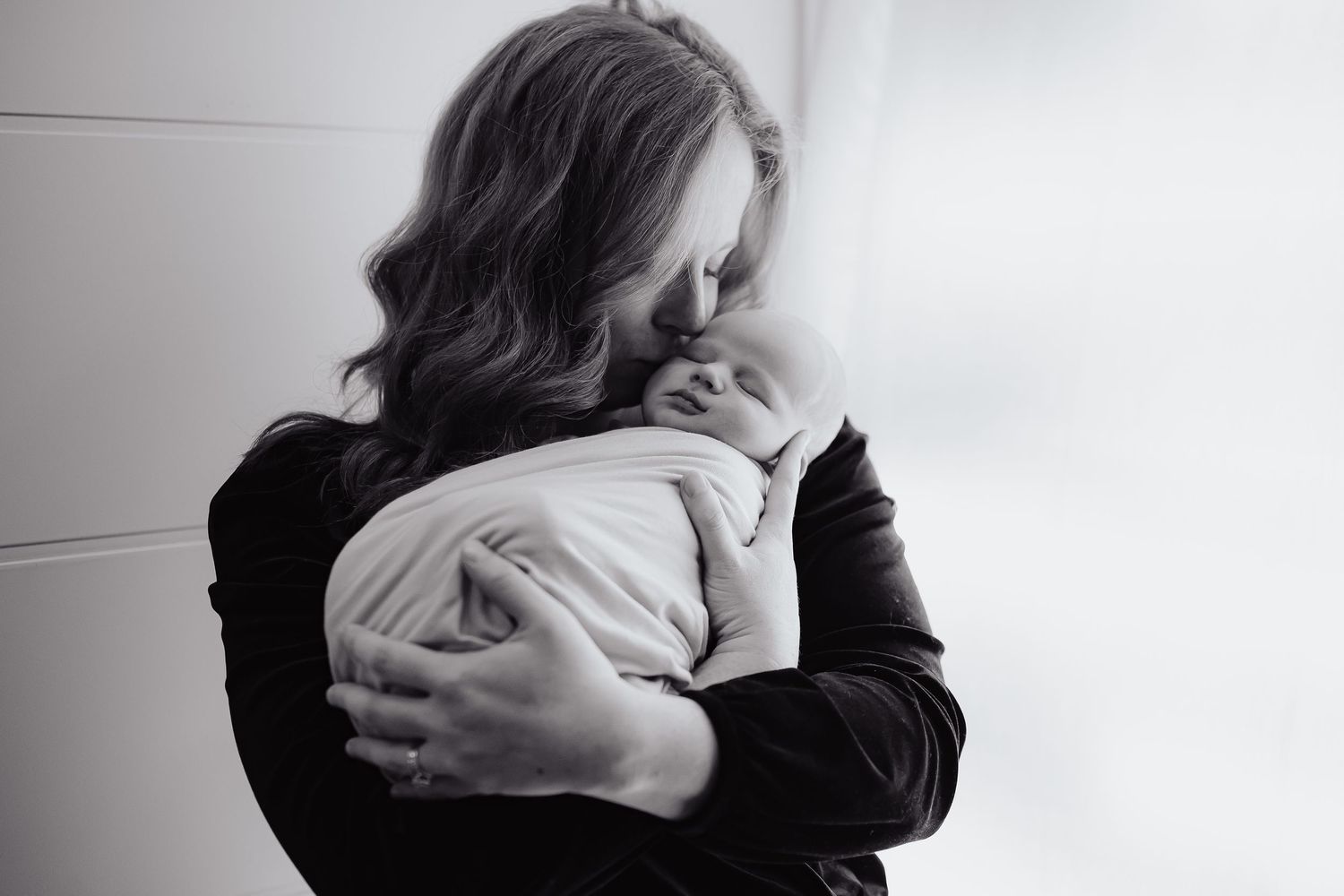 Series of intimate black and white portraits capturing tender parental moments.