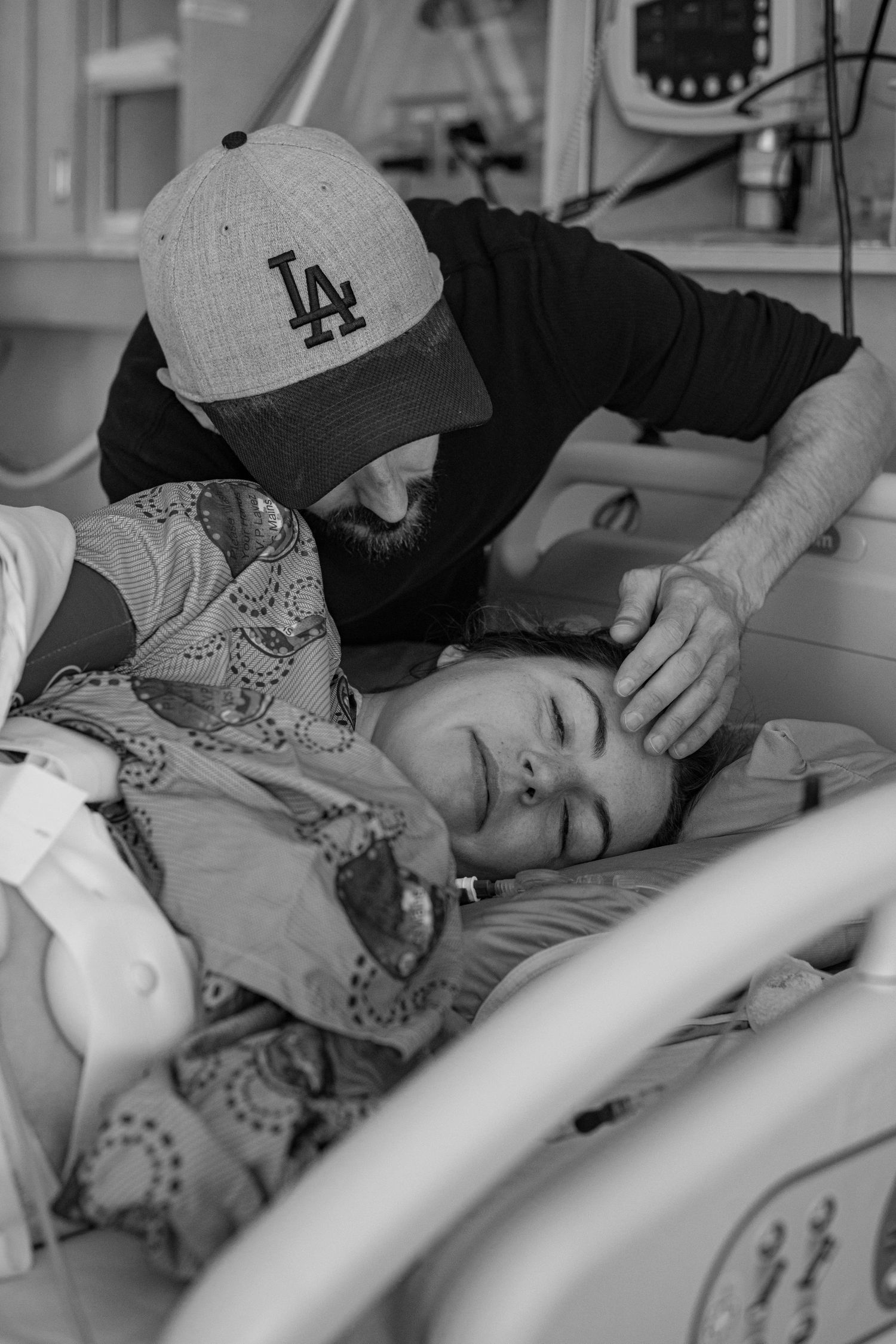 Patient receiving care in hospital bed. Birth Photographer Ontario