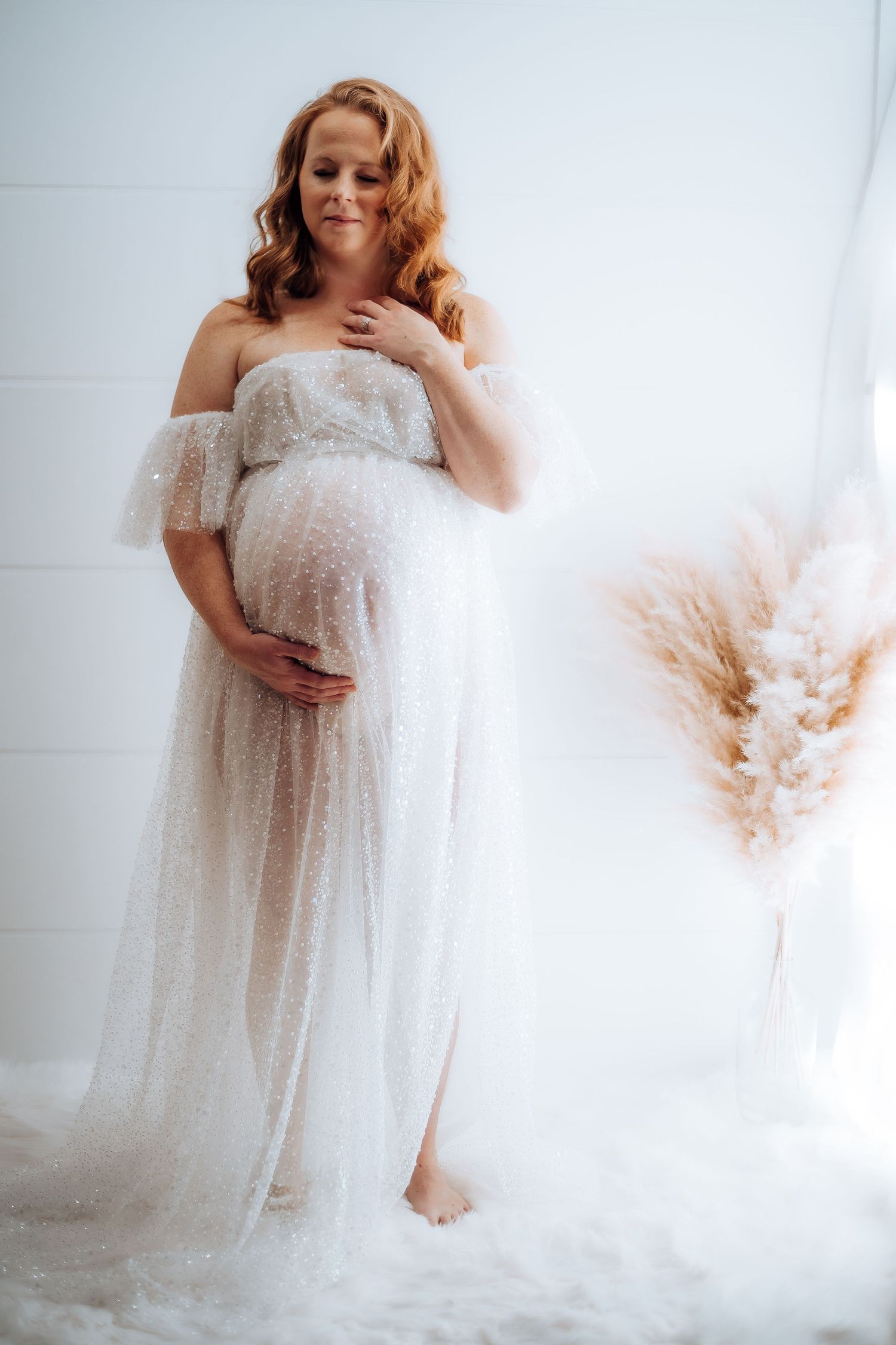Dreamy maternity session featuring delicate lace dress and soft window lighting. Maternity photographer Ontario