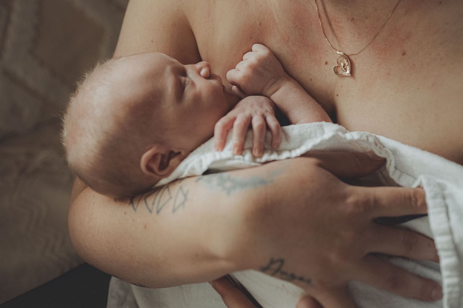 Intimate newborn photography session with soft natural lighting.