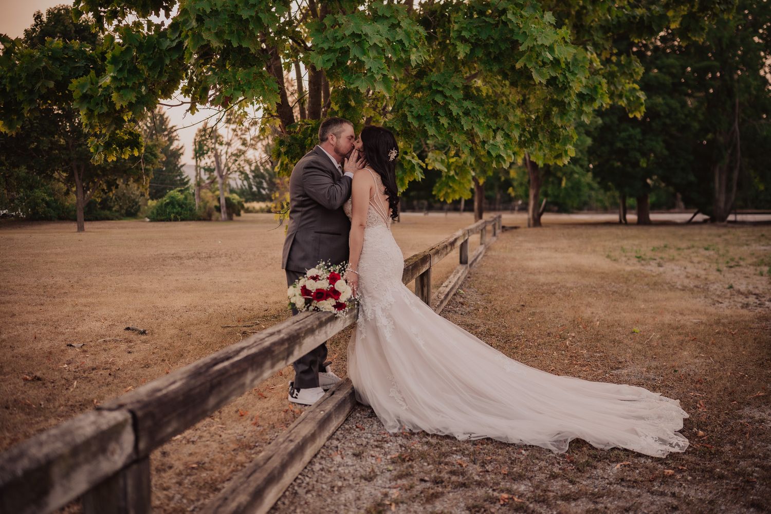 Romantic garden setting with trees and natural pathways at golden hour.