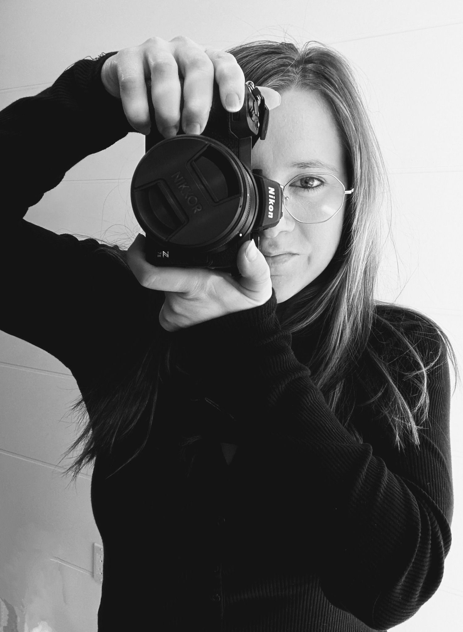 Black and white portrait series showing a photographer taking self portraits with a DSLR camera in different angles.