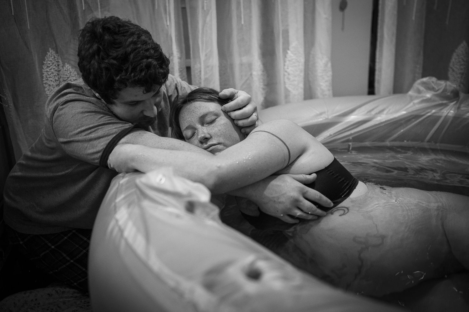 Emotional black and white image capturing an intimate birthing moment. Birth Photographer Ontario
