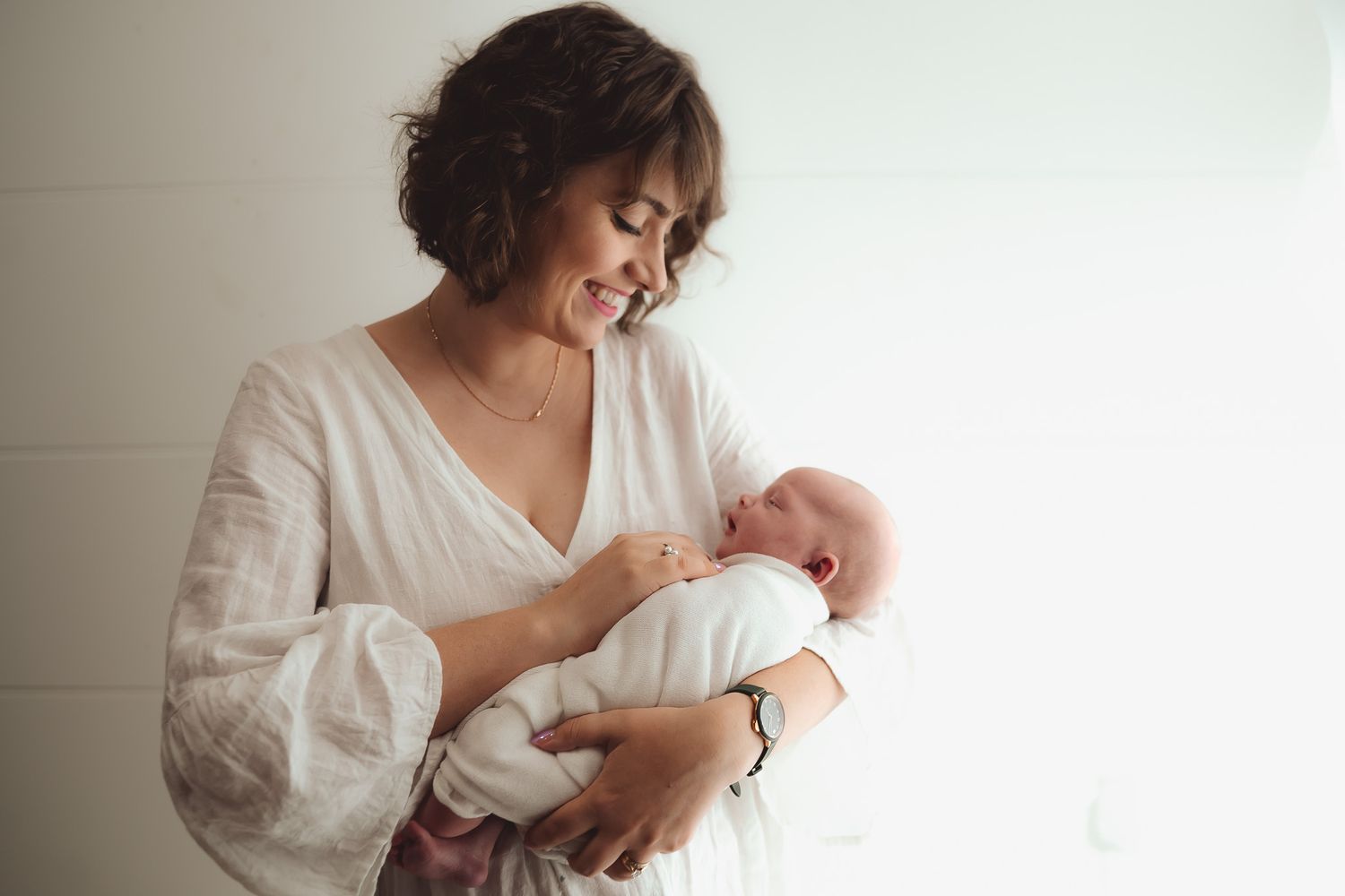 Bright and airy lifestyle photography session with white decor and natural lighting.