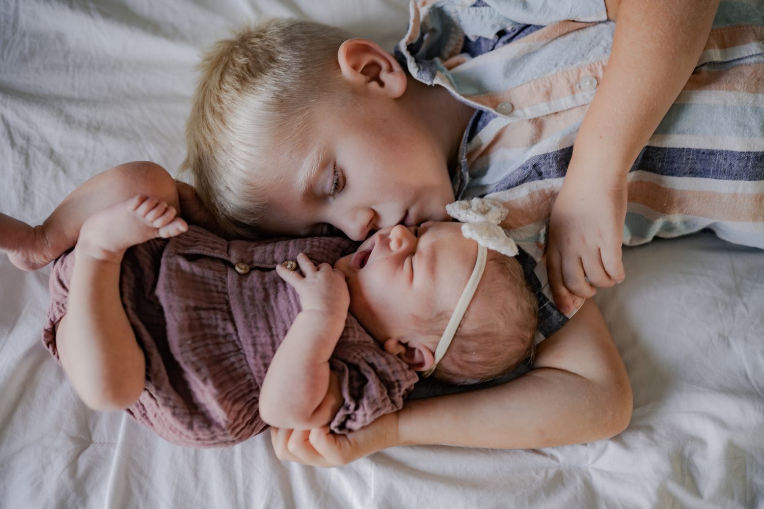 Candid lifestyle photos of relaxed moments with a baby on soft bedding.