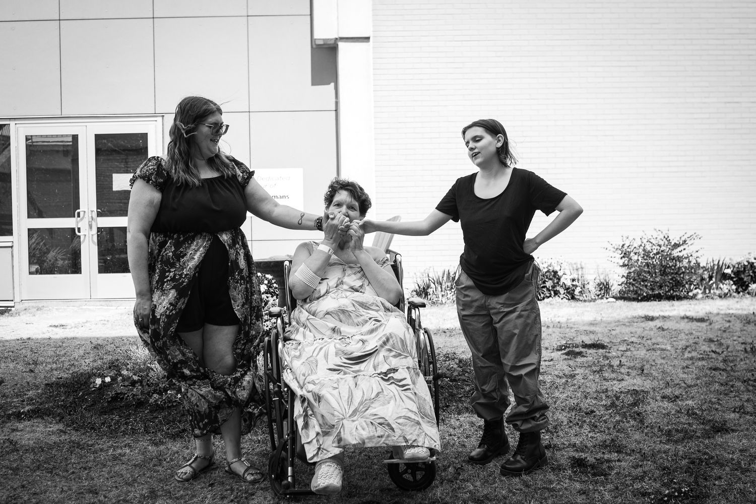 Black and white photo sequence showing caring interaction with grandmother, daughter and granddaughter outside building.