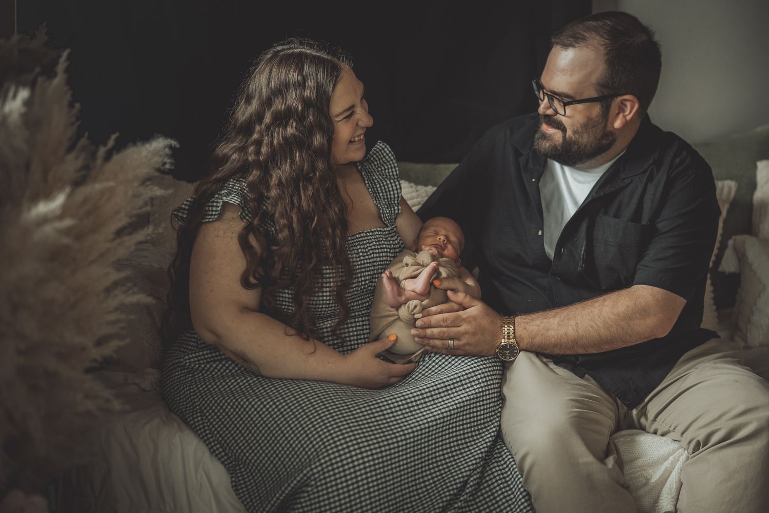Family lifestyle session on grey couch showing intimate moments.