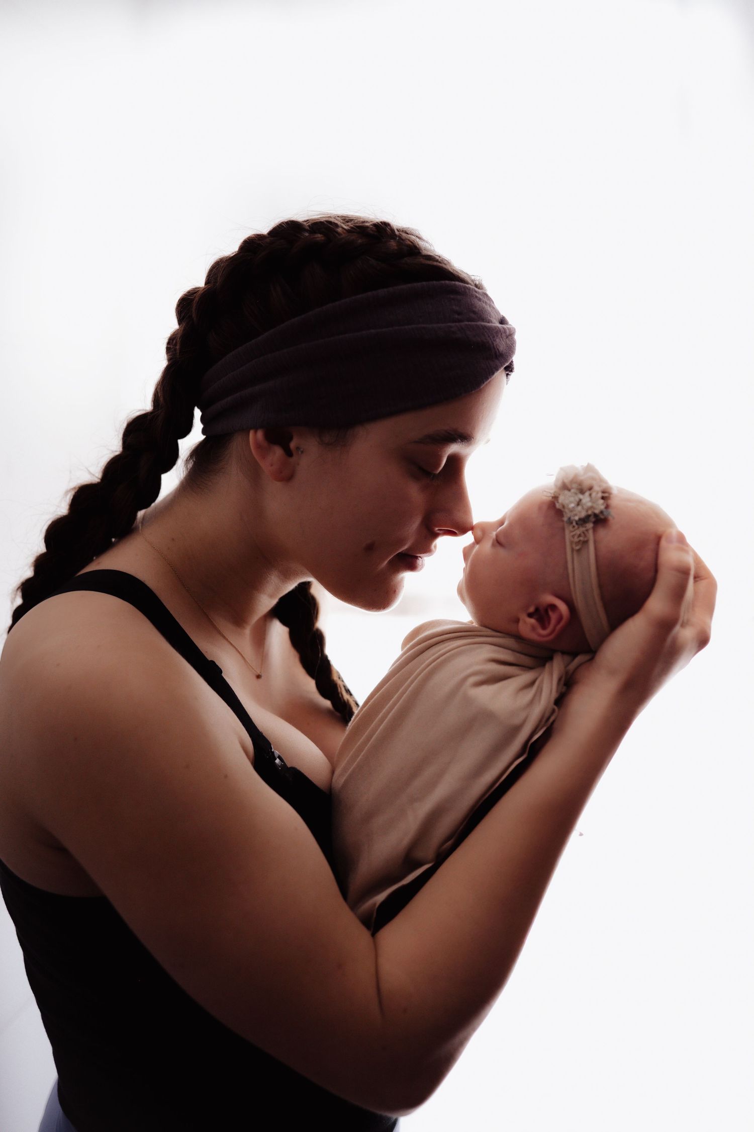 Black and white silhouette series showing tender moments between parent and infant.