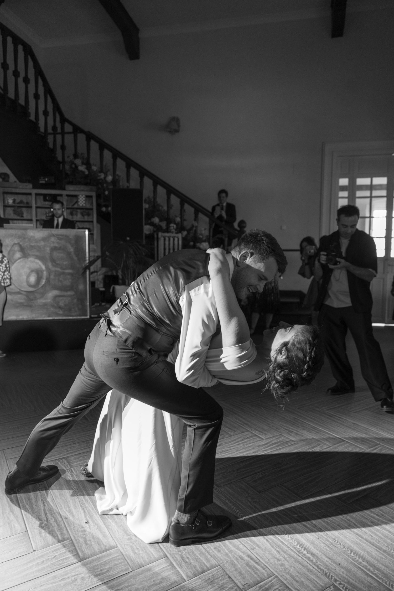 Series of dance moves performed on a light colored floor in a spacious room.