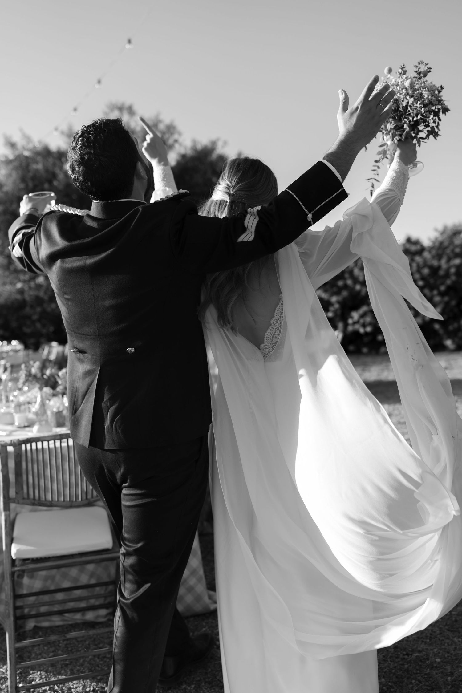 A sequence of black and white photos showing a couple dancing and twirling at an outdoor wedding celebration.