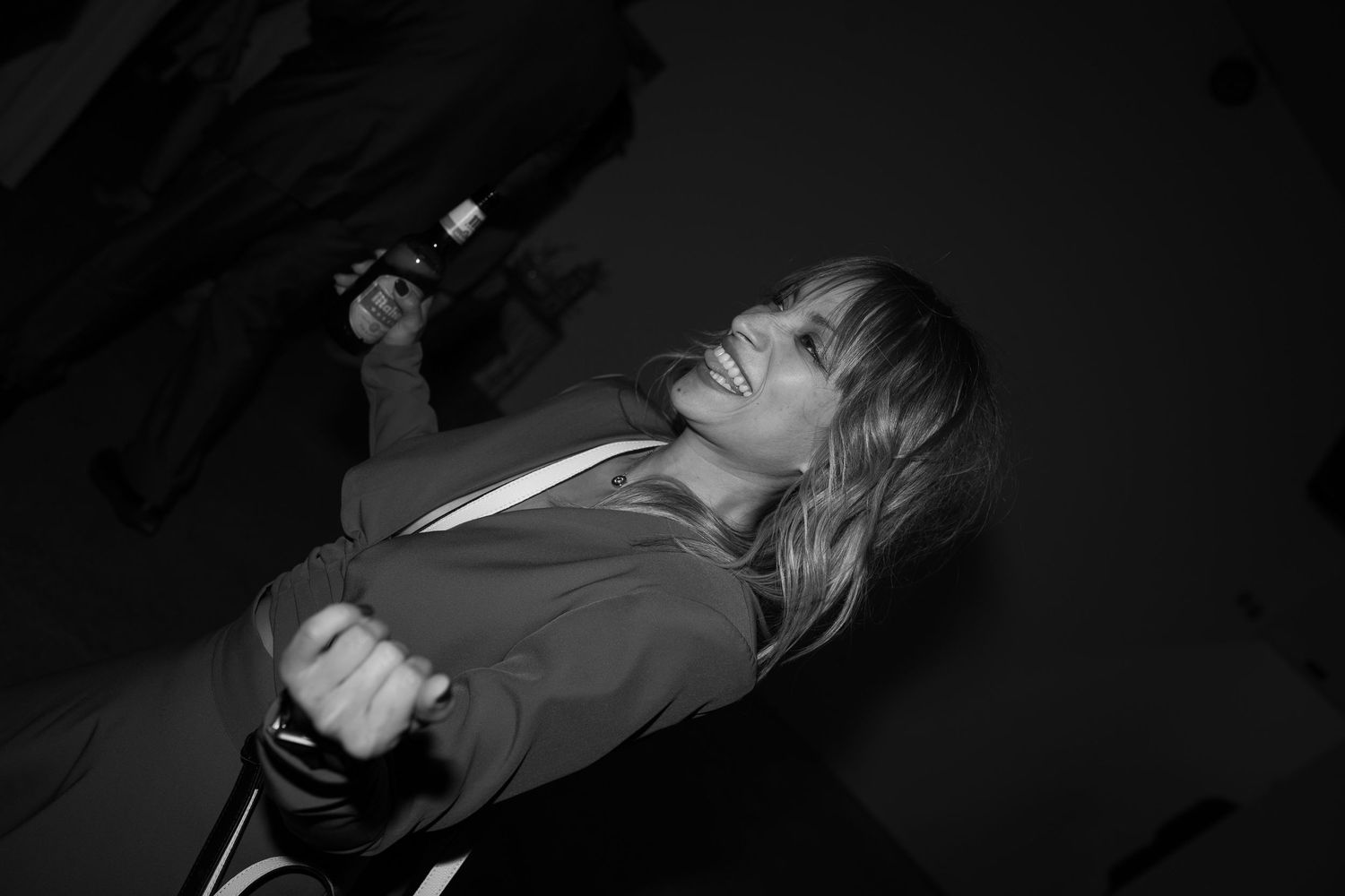 Dramatic black and white photo capturing emotional moments at a wedding celebration.