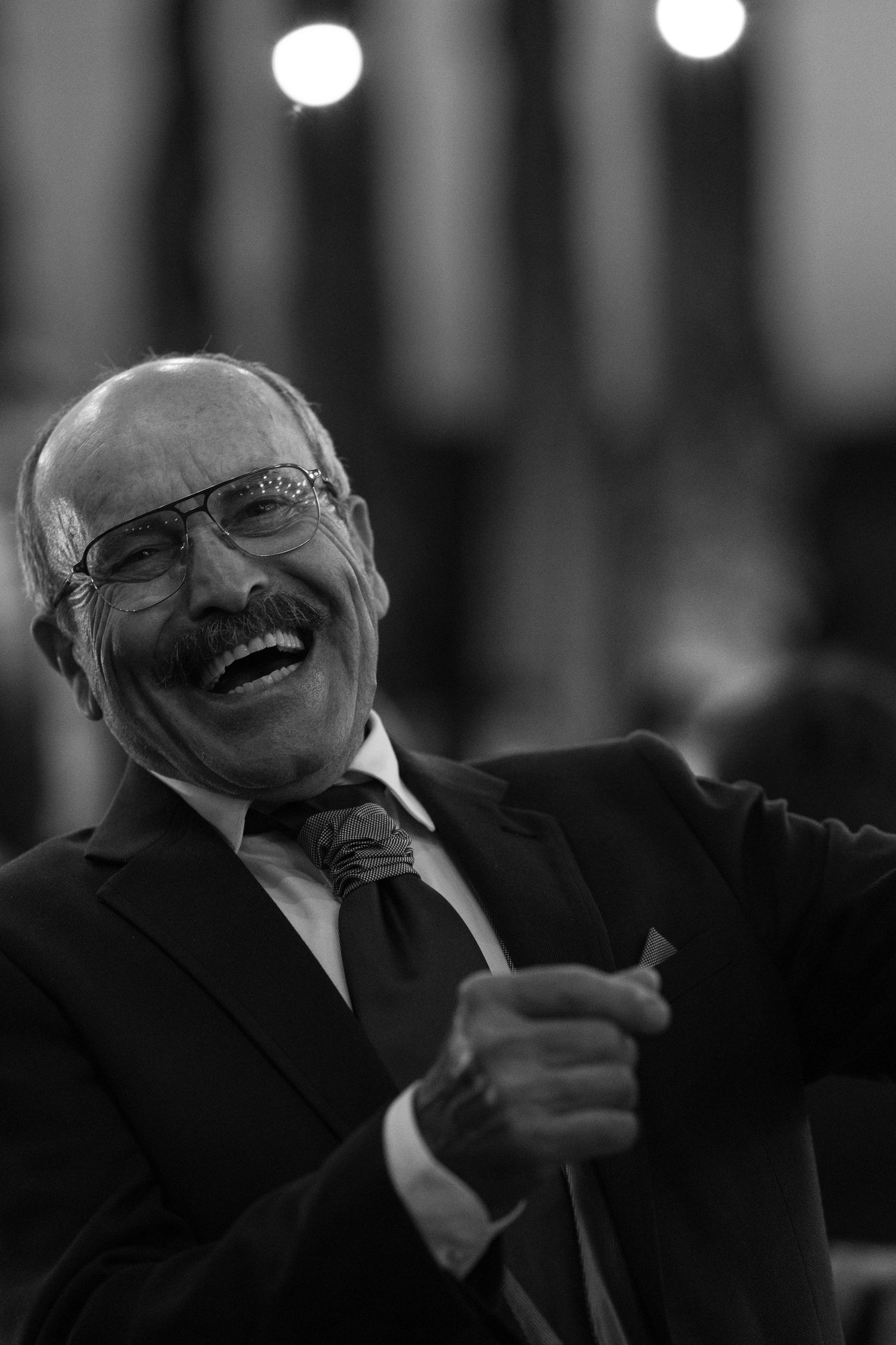 Black and white sequence showing joyful expressions and laughter during a celebration.