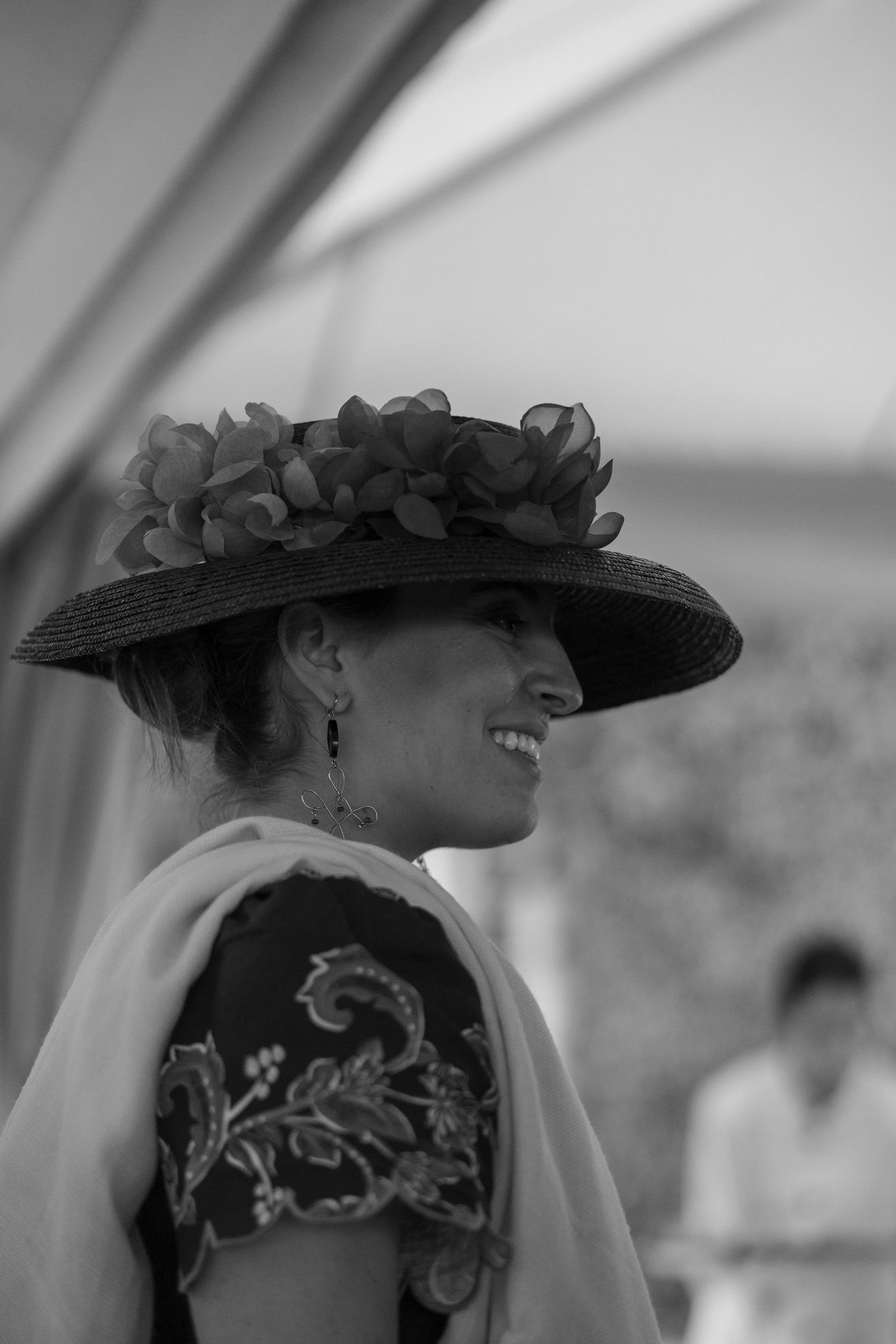 Elegant black and white photo of decorative hats with floral details.