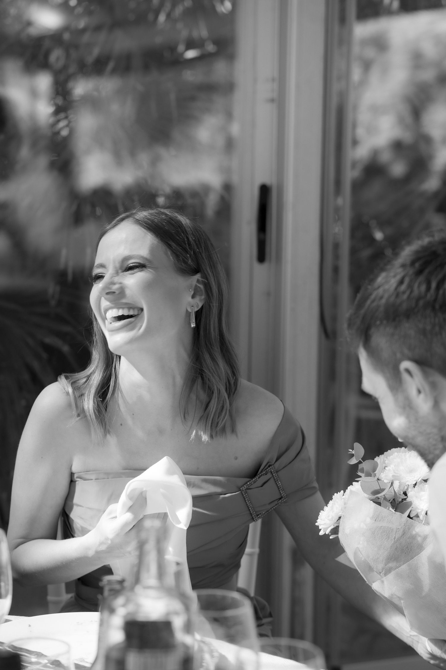 A joyful candid moment captured in black and white at a celebratory gathering.