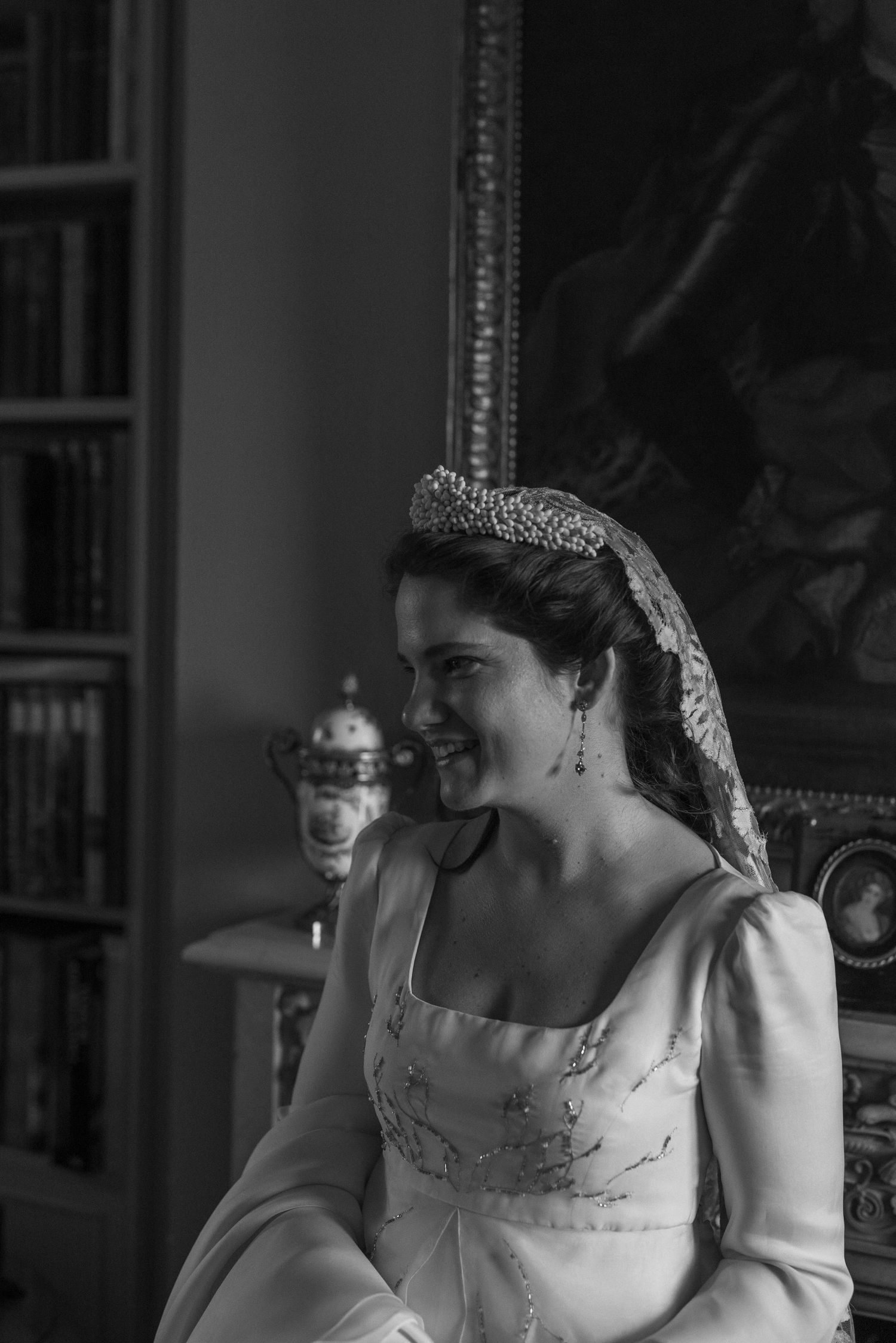 Elegant bride in black and white wearing a tiara and formal gown during wedding portrait session.