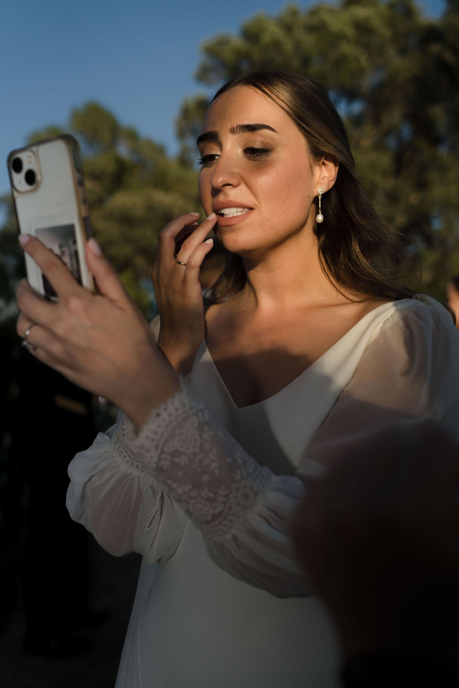 Artistic closeup shots of someone using a phone during golden hour lighting.