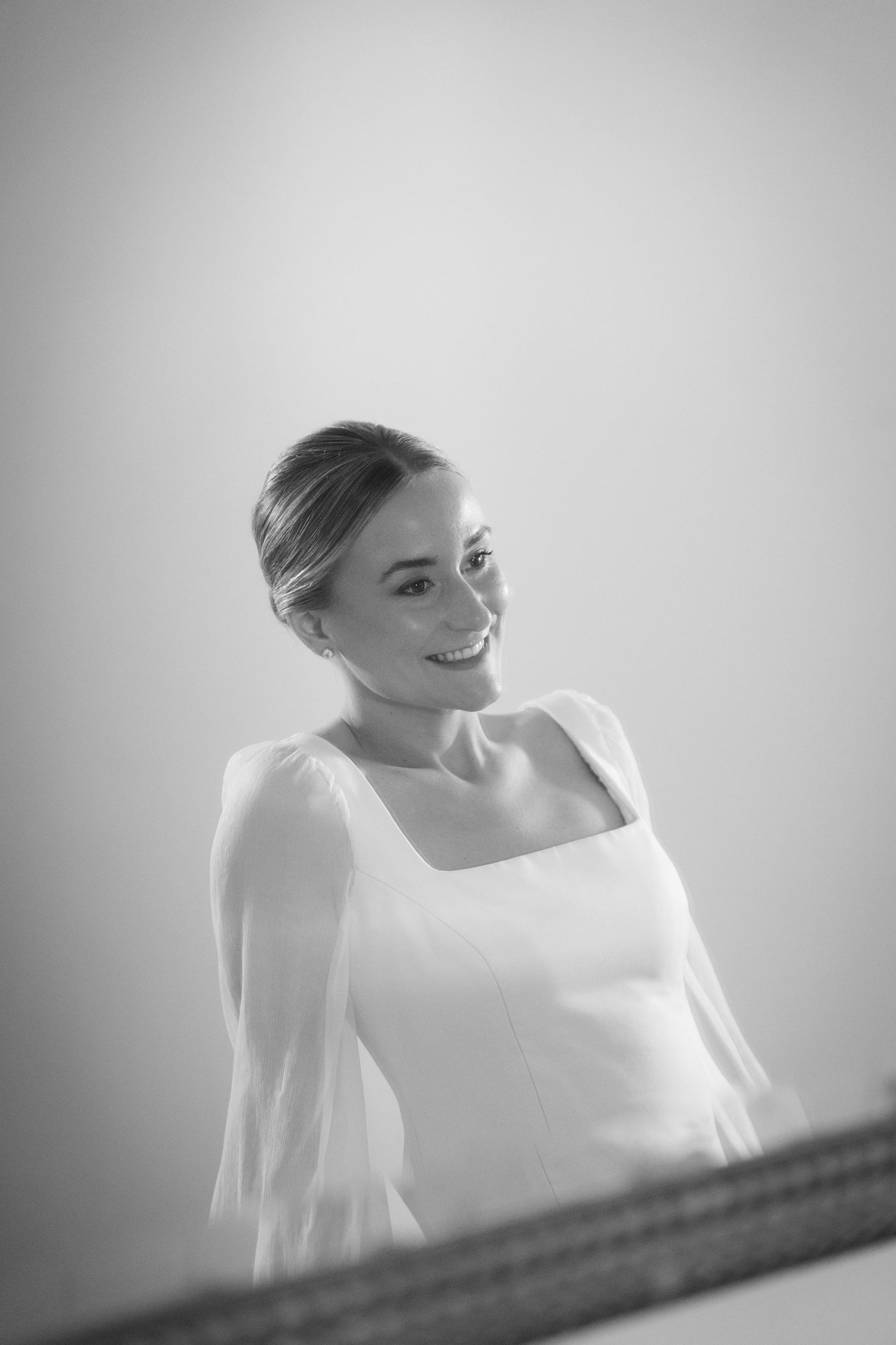 Elegant black and white portrait taken from above showing a woman in a wedding dress.