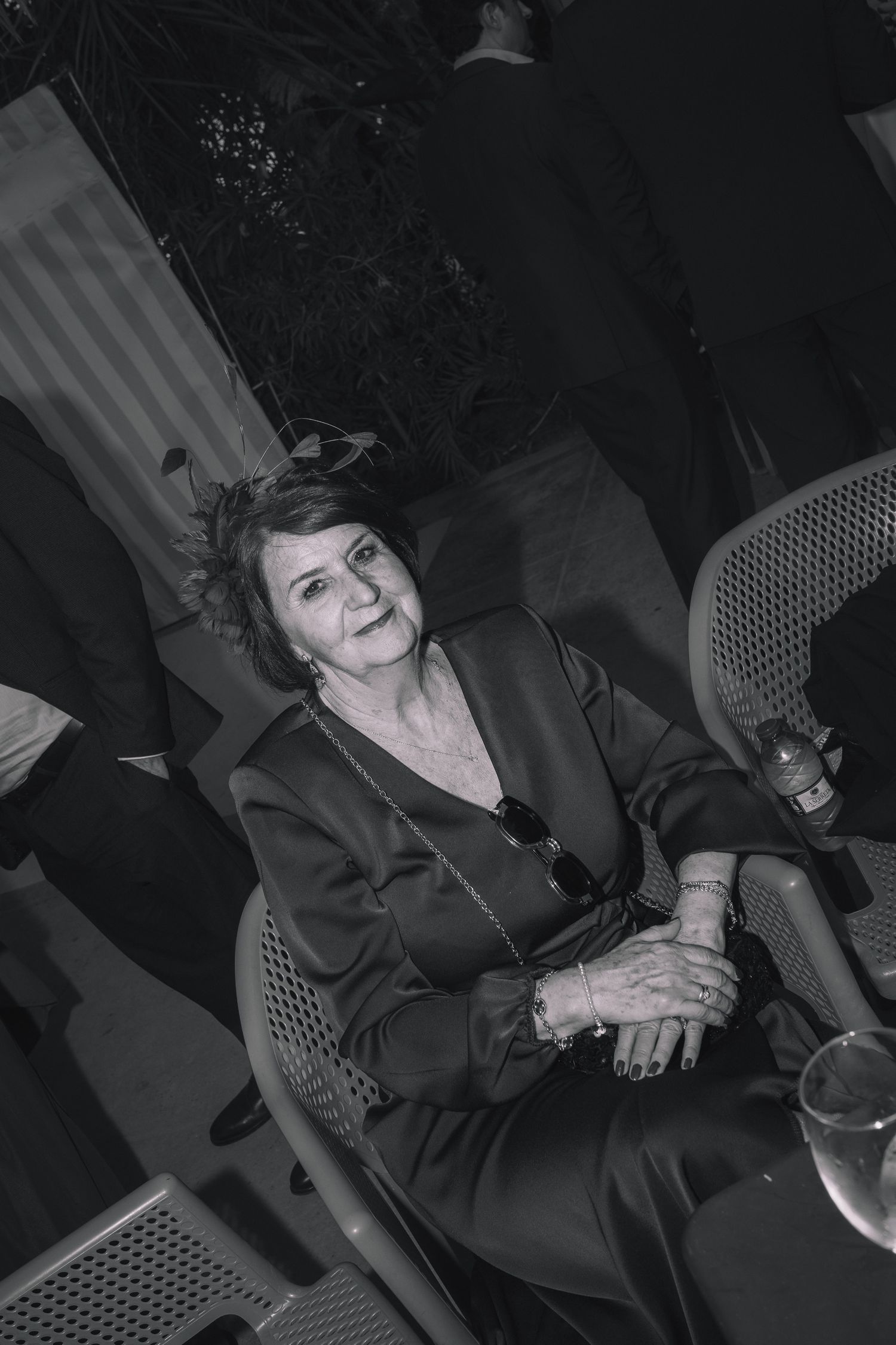Black and white candid shot of guests enjoying themselves at a formal evening event.