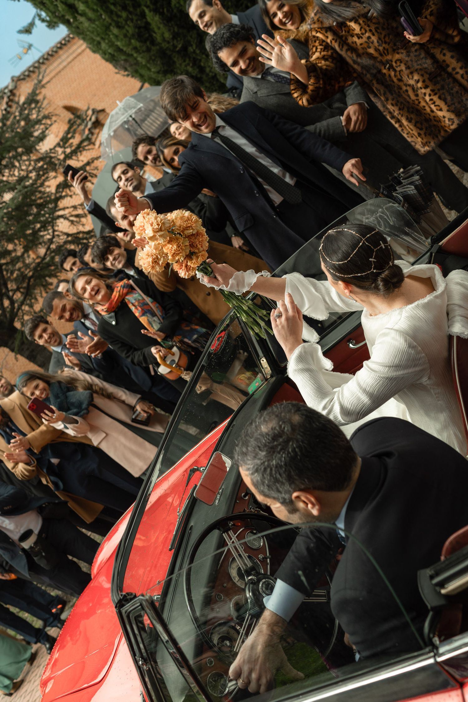 Musicians perform in an outdoor concert setting with string instruments and casual attire at sunset.