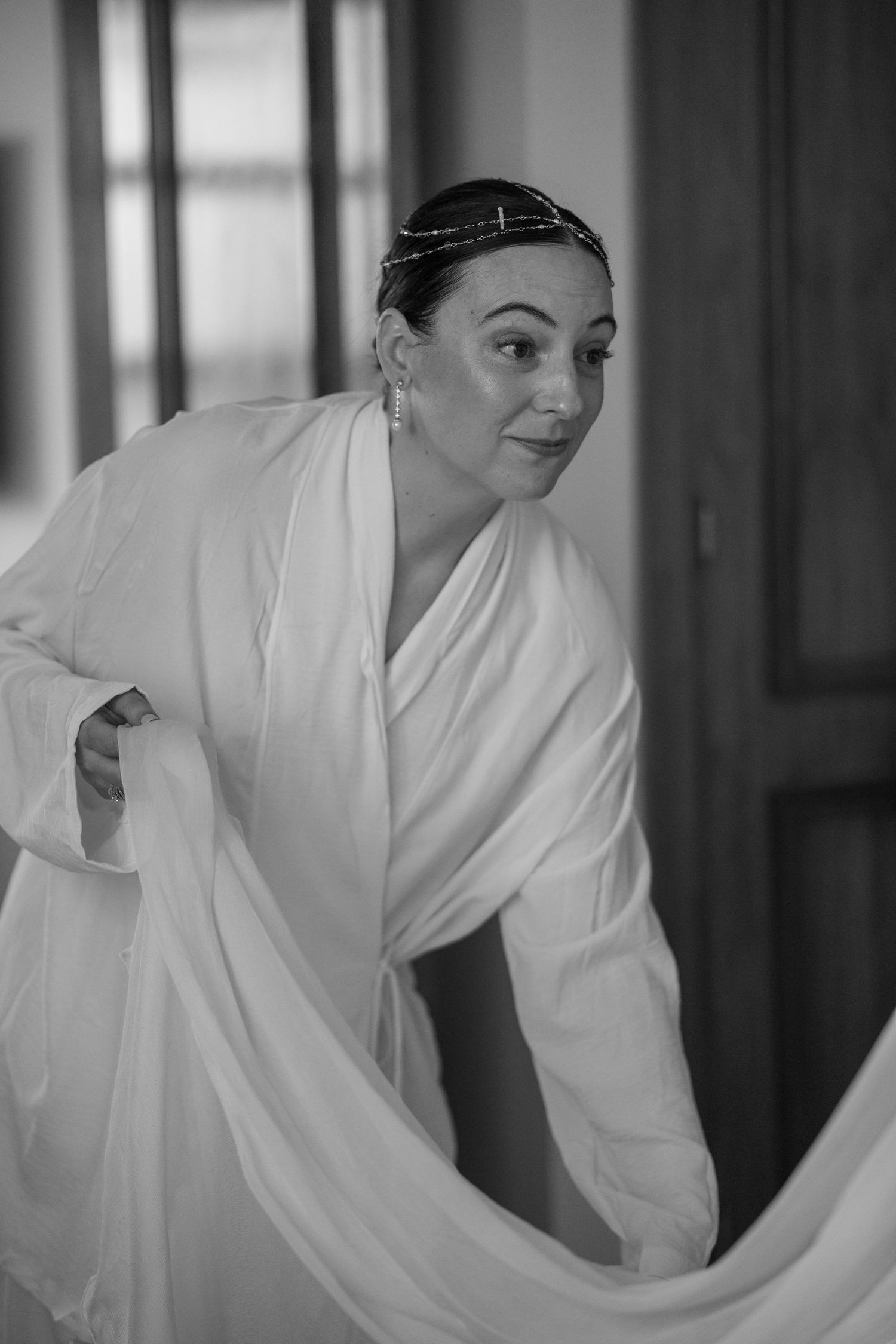 Person in white robe getting ready in morning light.