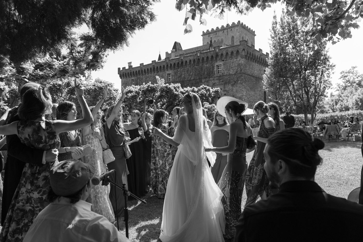 Wedding celebration with guests gathered outdoors.
