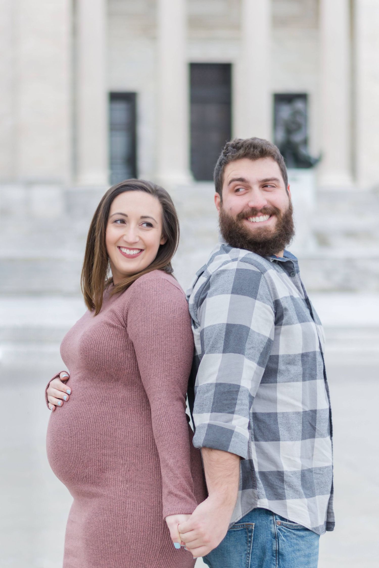 A couple poses together in a series of romantic outdoor photos against a white building.