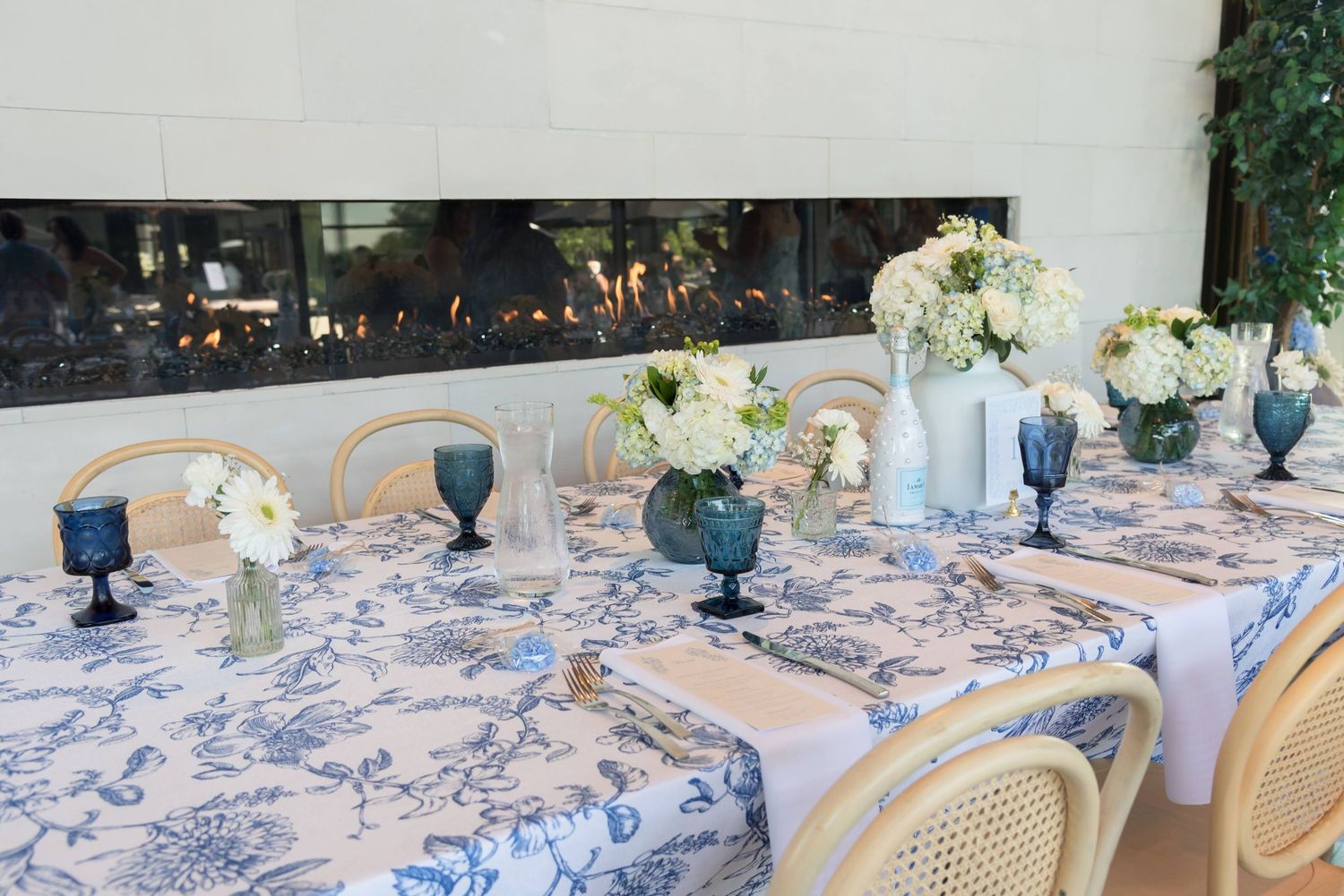 Elegant table settings with blue and white decor for a formal dining event.