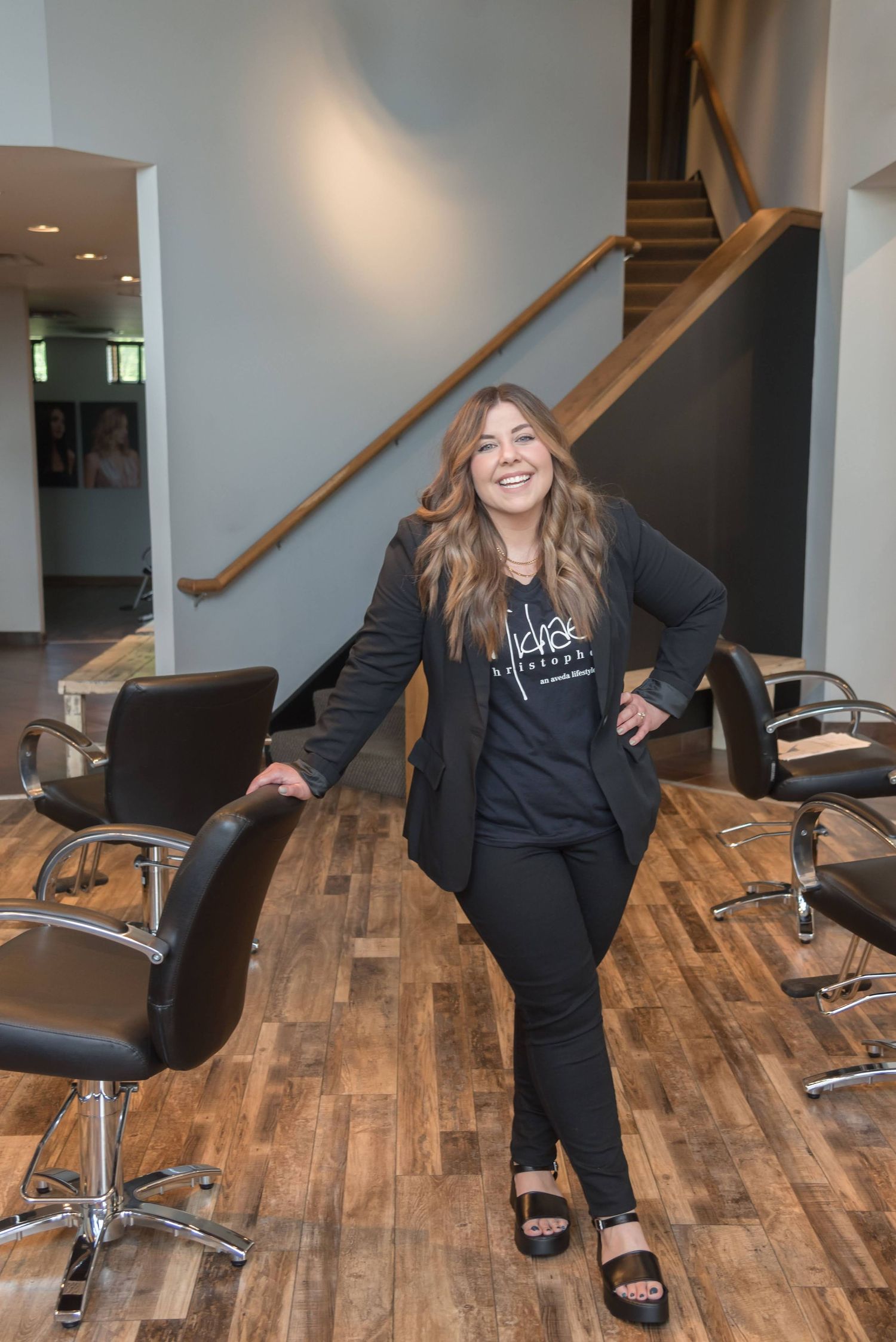 Playful sequence of someone posing on salon chairs in a modern studio space.
