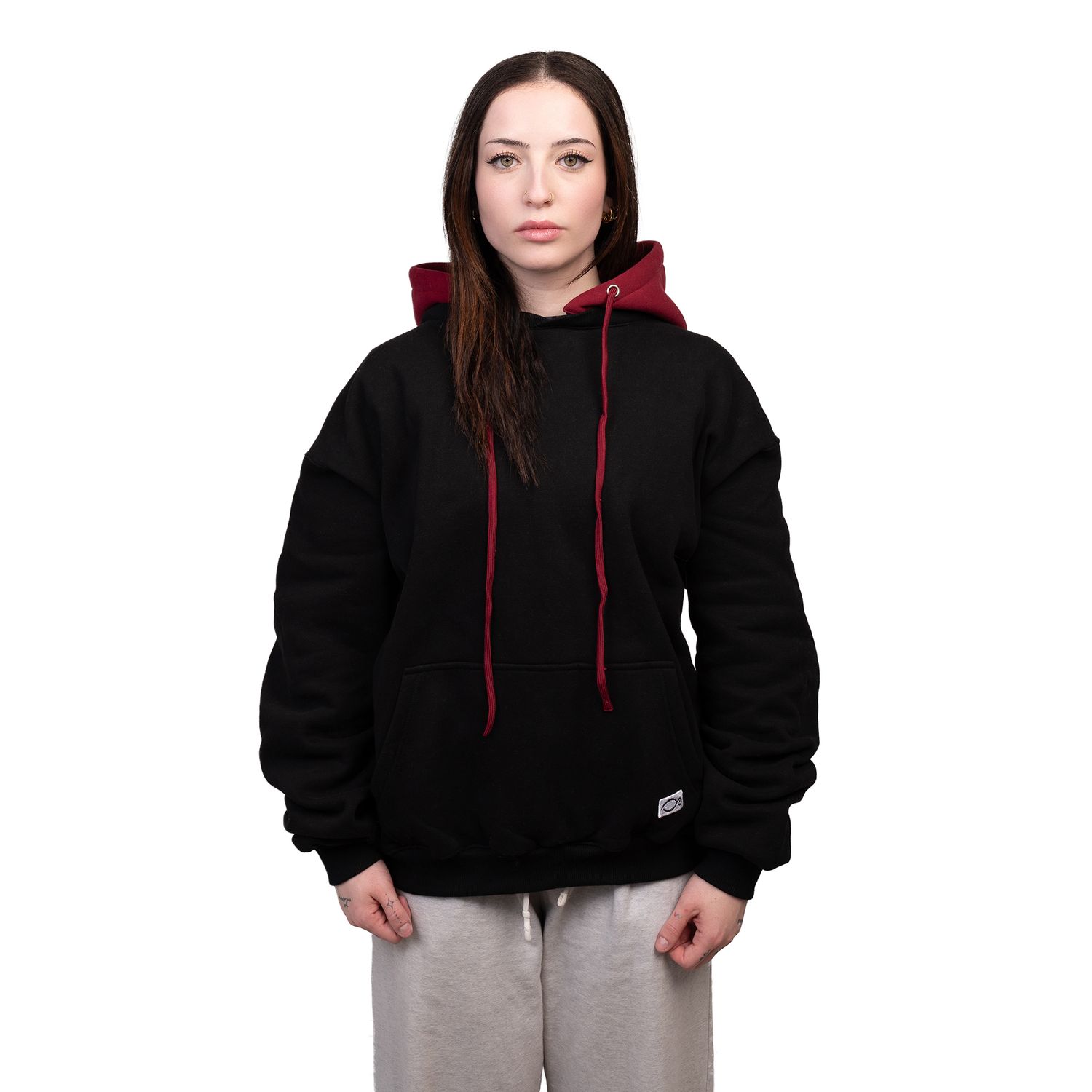 Person wearing a black hoodie with red drawstrings shown in multiple poses.
