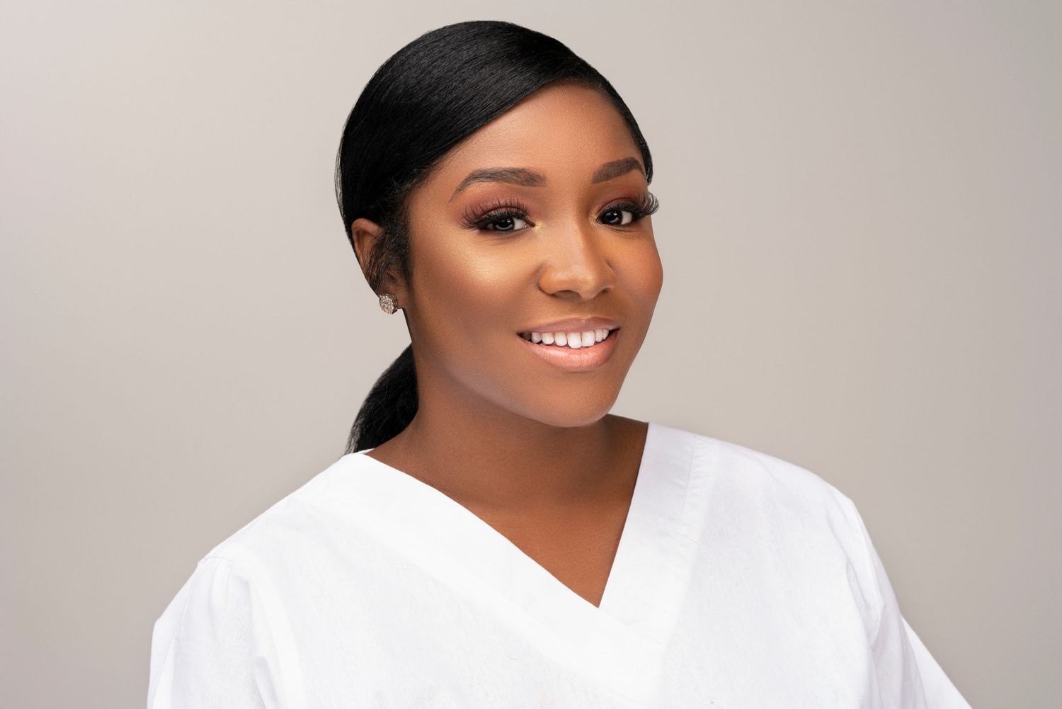 Professional studio portraits featuring bright white attire and elegant poses against a light neutral background.