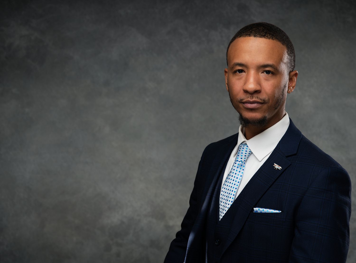 Professional studio portrait series showing different poses and expressions against a dark gray backdrop.