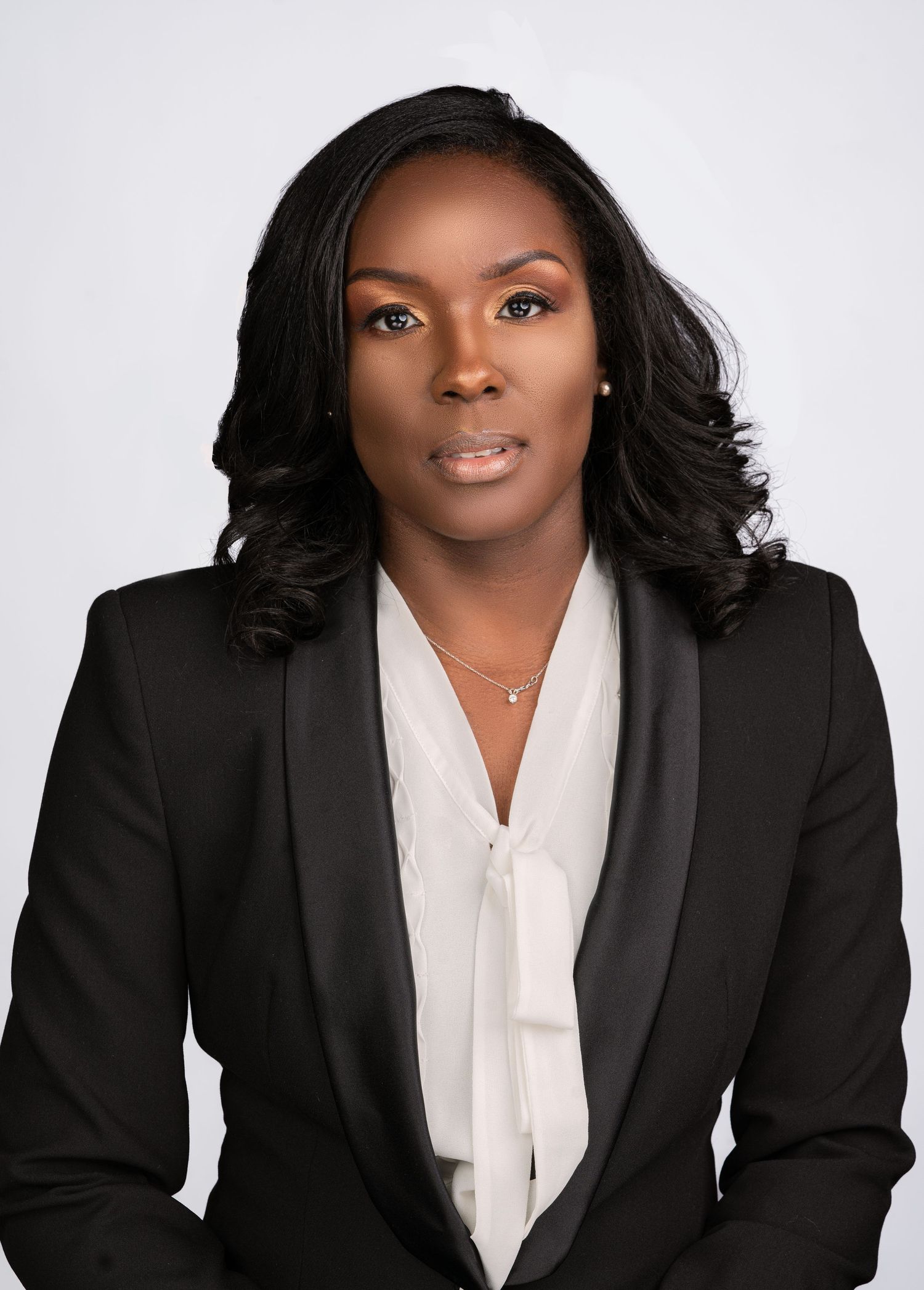 A professional portrait series showing a career person in a black blazer and white blouse against a light background.