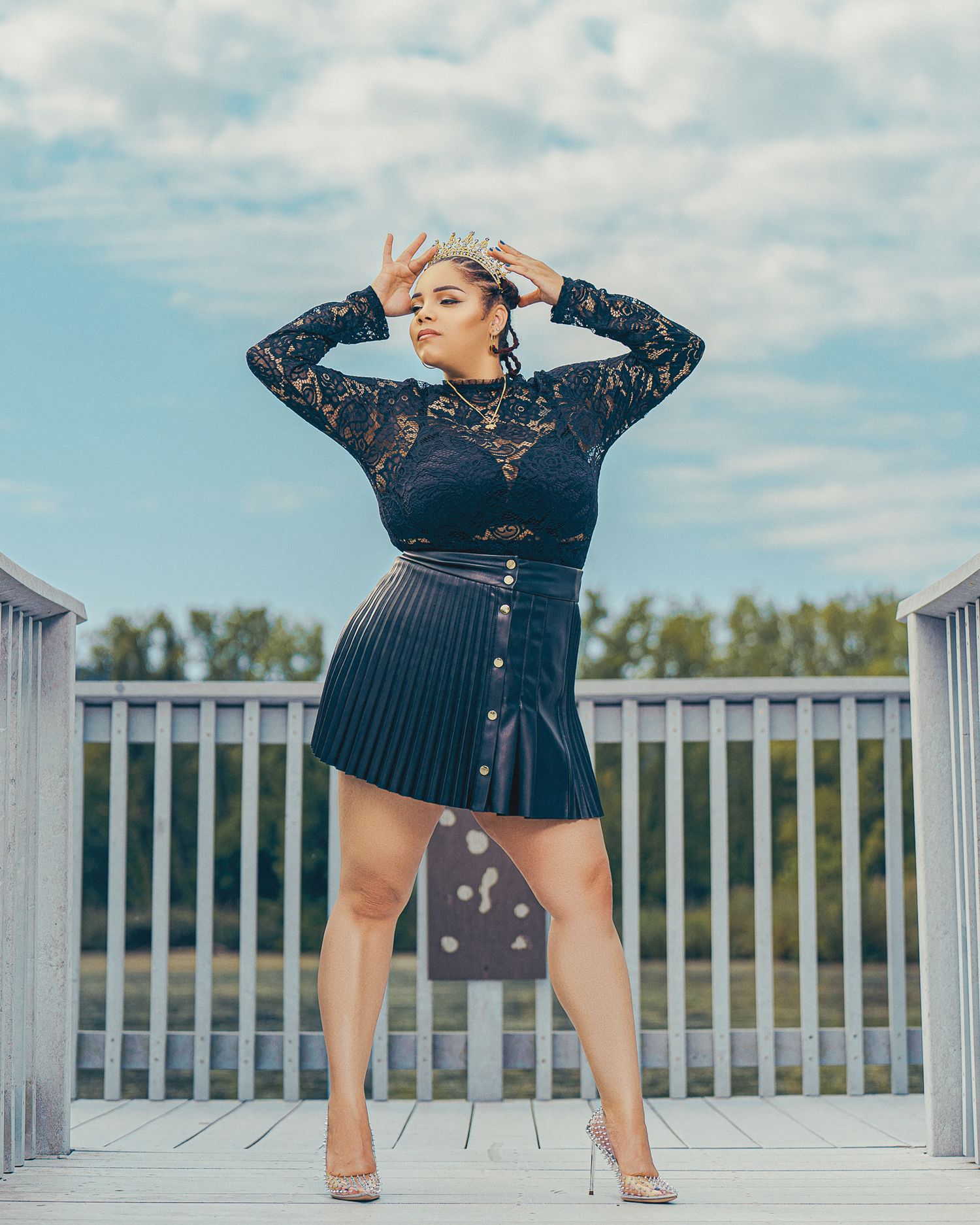 Navy blue lace romper being showcased in multiple poses on a wooden deck with lake views in the background.