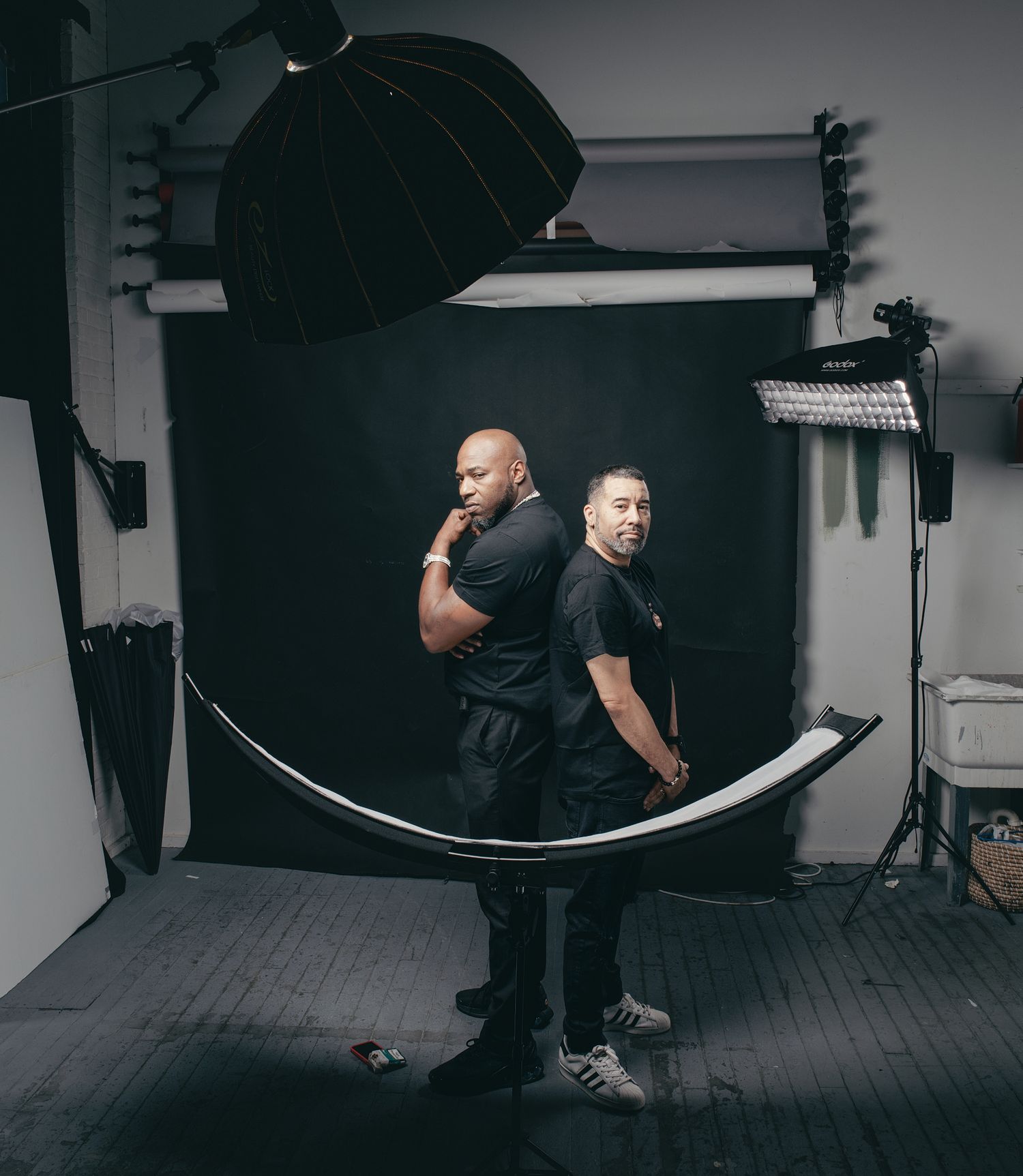 Studio lighting equipment and reflectors set up in a professional photography studio for a photo session.