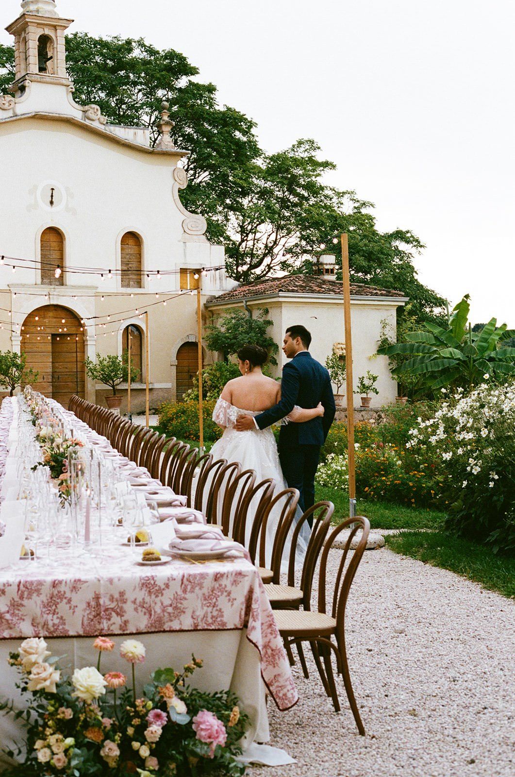 Couple look at their Wedding breakfast table at destination wedding at Villa Pellegrini in Italy on 35mm Film.