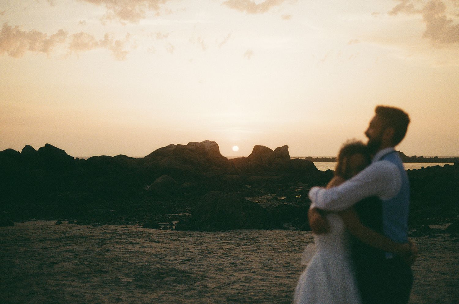 Copule kiss at Guernsey Wedding on the beach.