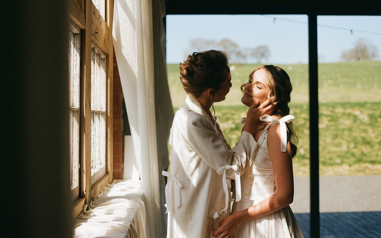 Same sex couple embrace at The Giraffe Shed wedding venue in Newtown, Wales. Image is on 35mm Film.