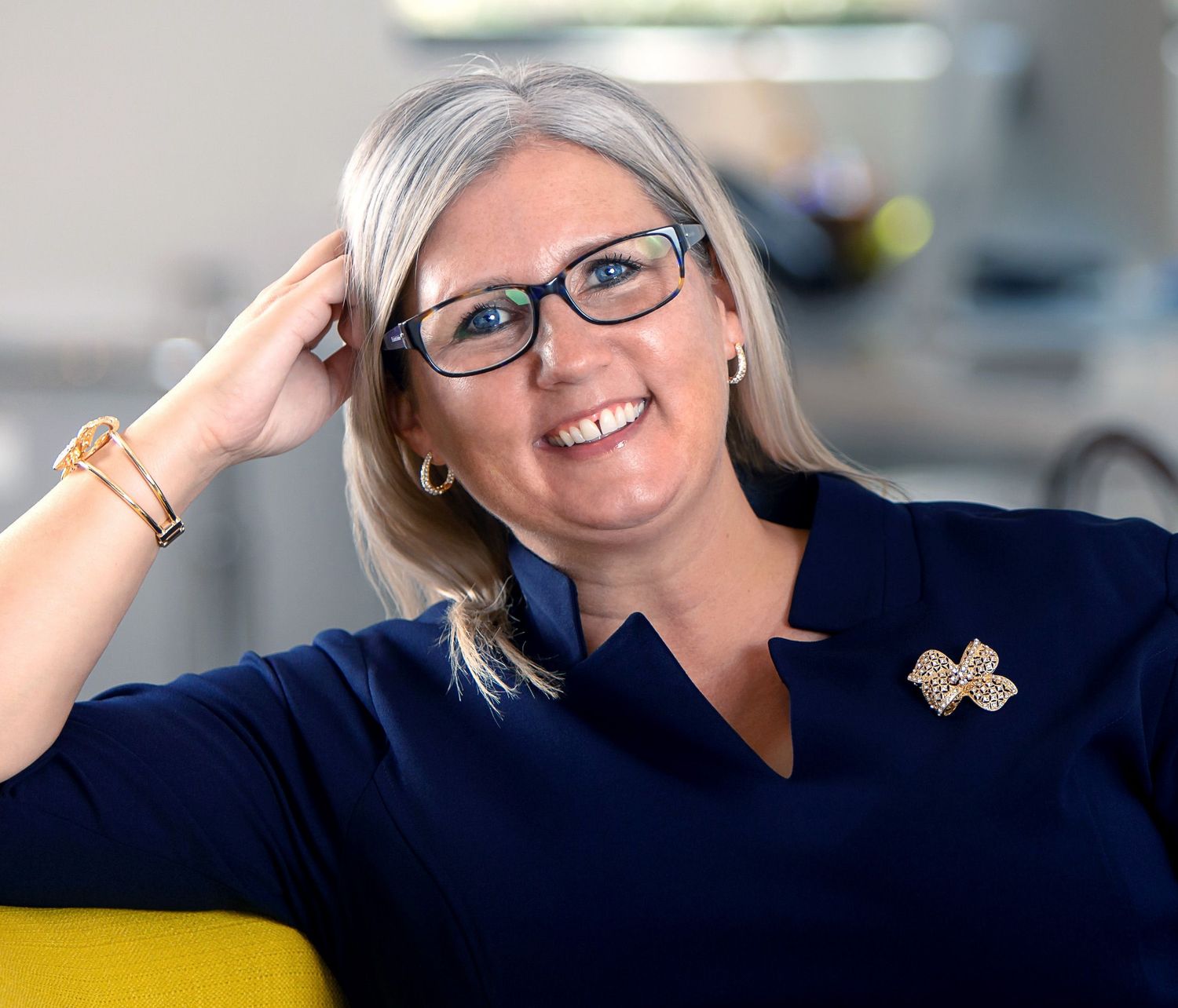 Professional portrait series of woman with silver hair and glasses showing various poses.