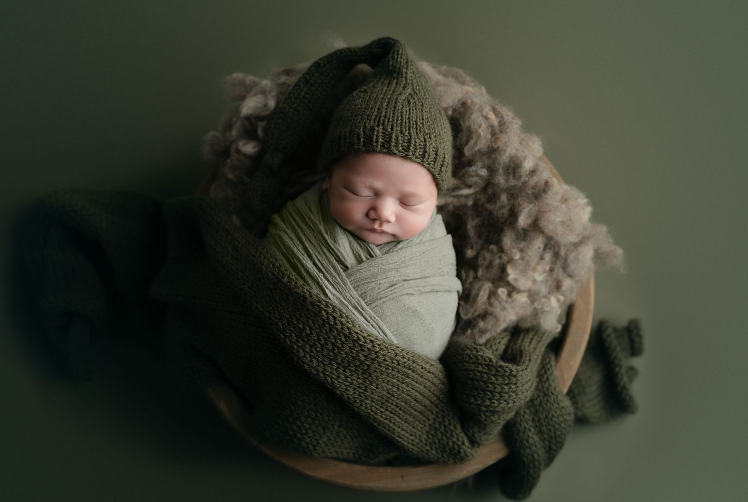 Baby on green backdrop. Hatched Newborn and Family Photography. Madison, Monona, Verona, Mount Horeb, WI