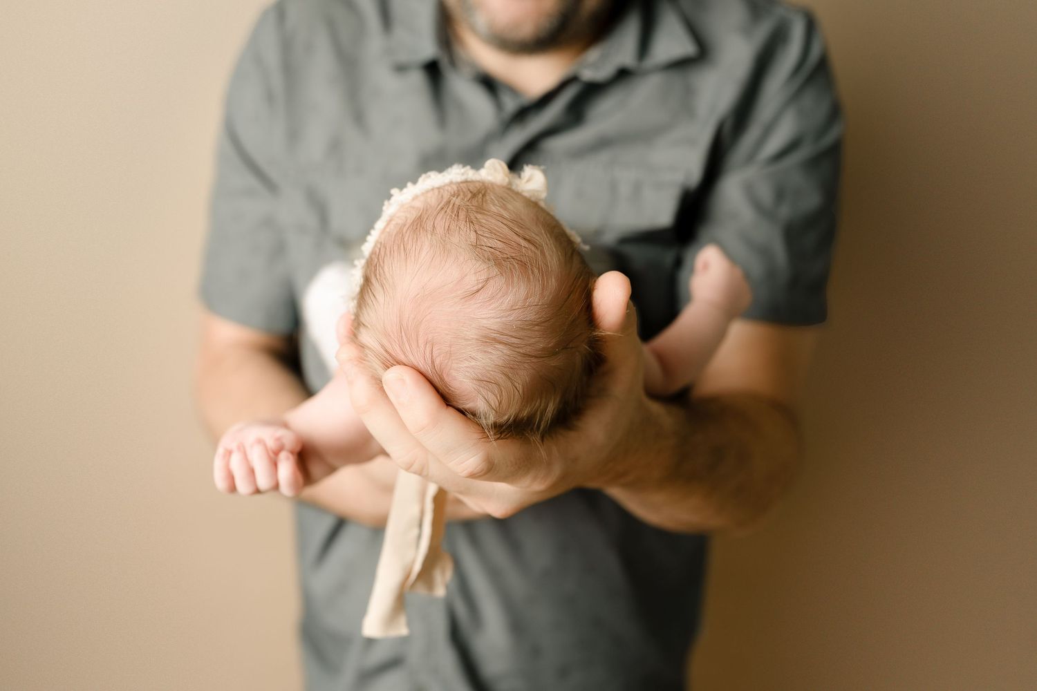 Baby in father's hands. Hatched Newborns. Madison, Mount Horeb, Verona, Middleton, Wisconsin.