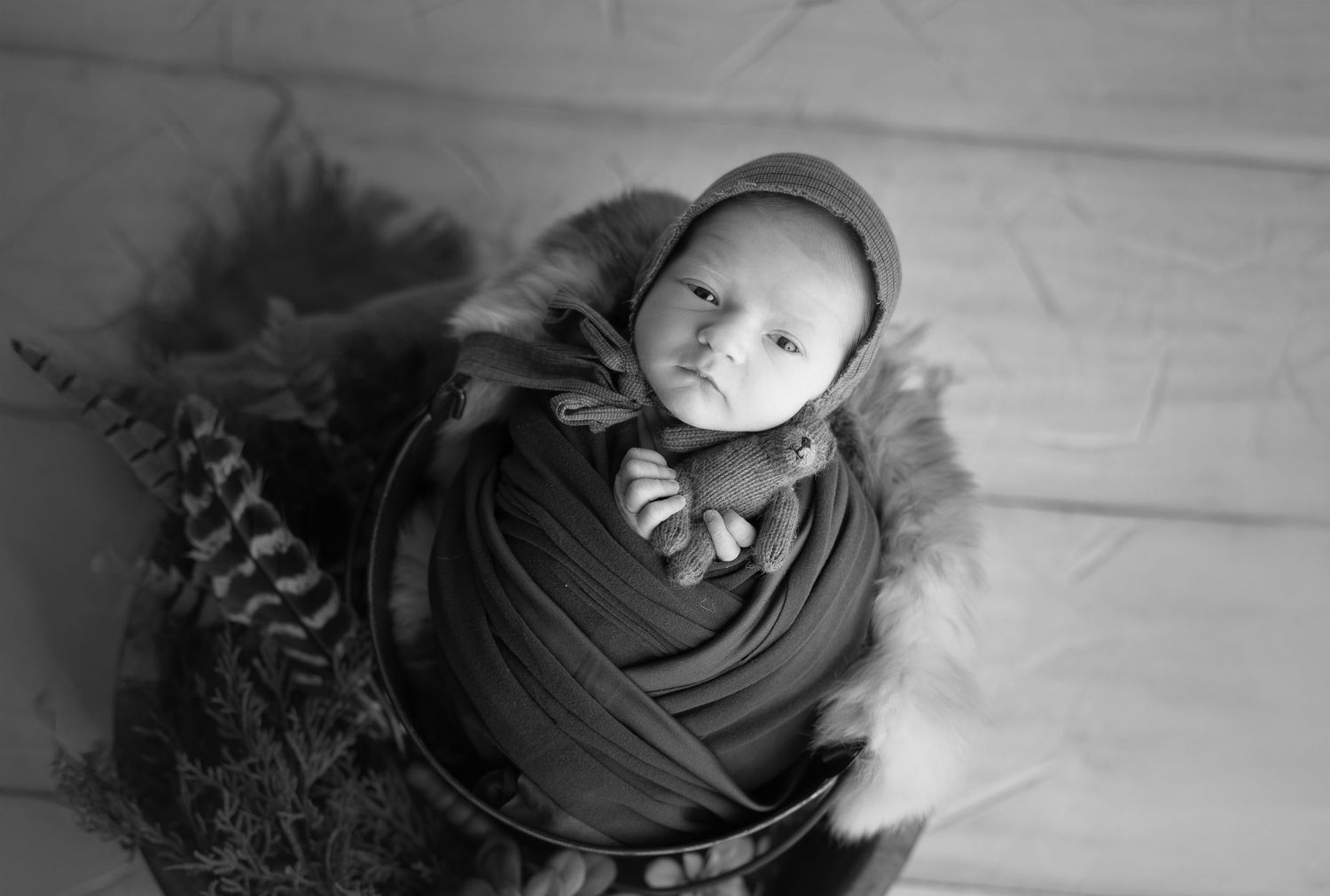 Baby holding a tiny bear. Madison, WI award winning newborn photos.