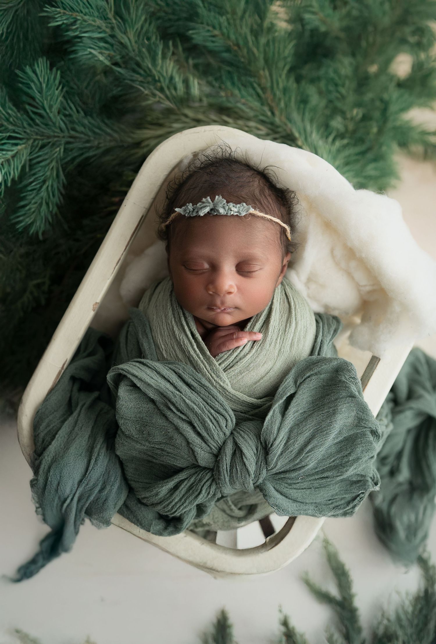 Baby with dramatic bow, studio newborn photography