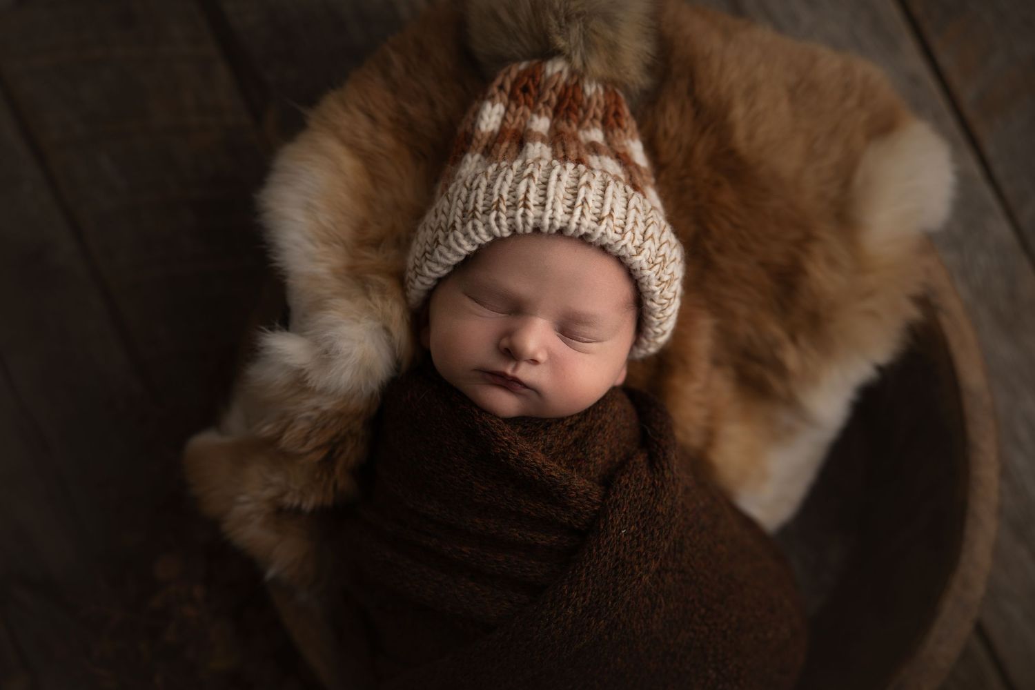 Beautiful fall photo of a baby boy in brown.