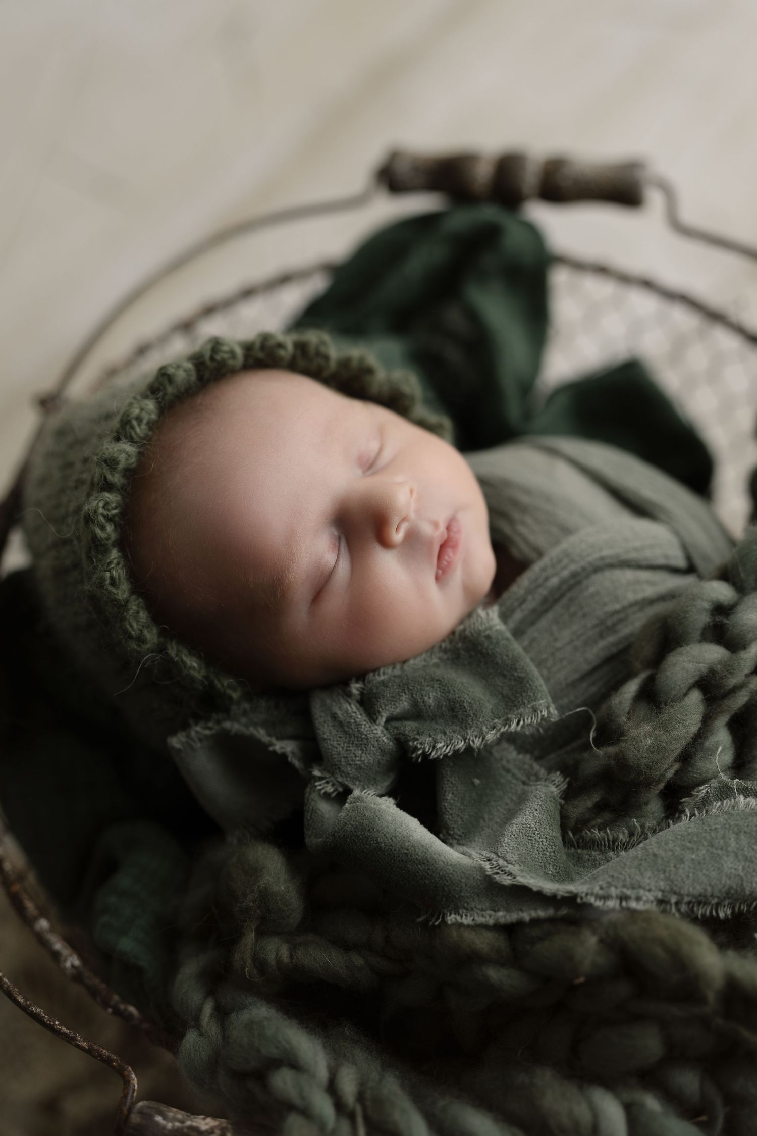 Baby in green with bonnet. Hatched Newborn and Family Photography. Madison, Monona, Mount Horeb, Verona, Wisconsin