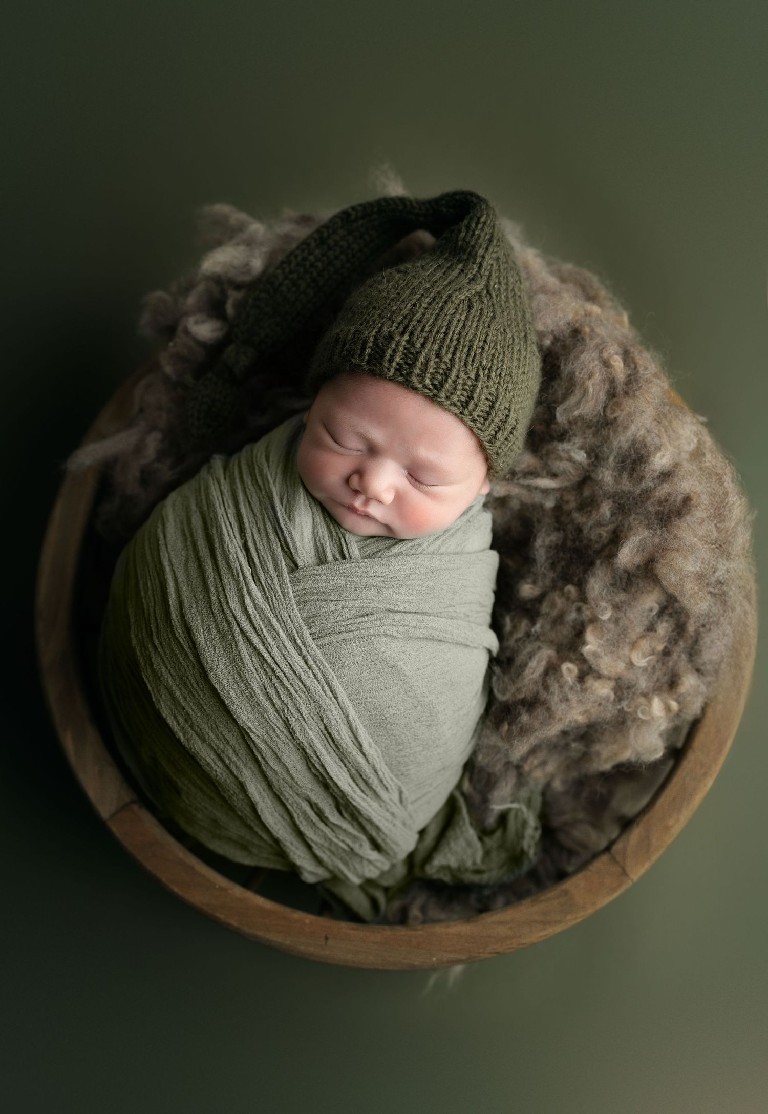 Baby on green backdrop. Hatched Newborn and Family Photography. Madison, Monona, Verona, Mount Horeb, WI