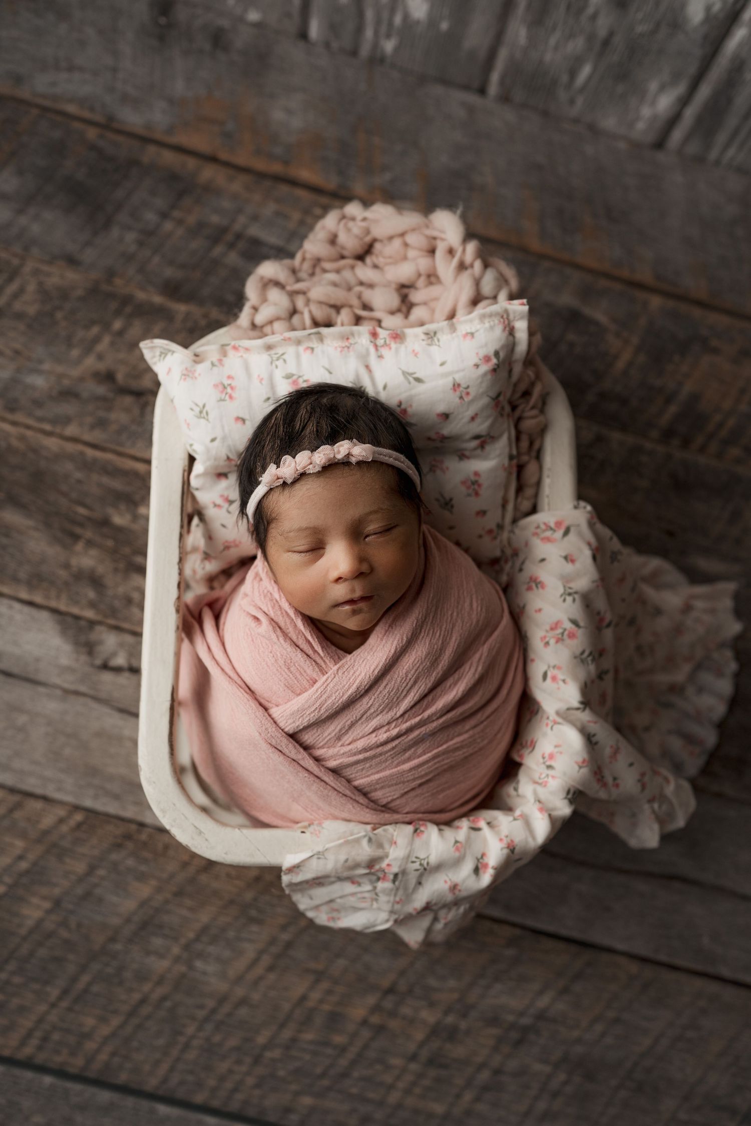 Baby in basket with floral pillow. Verona, WI. Mount Horeb, Wi. Madison. Wisconsin.