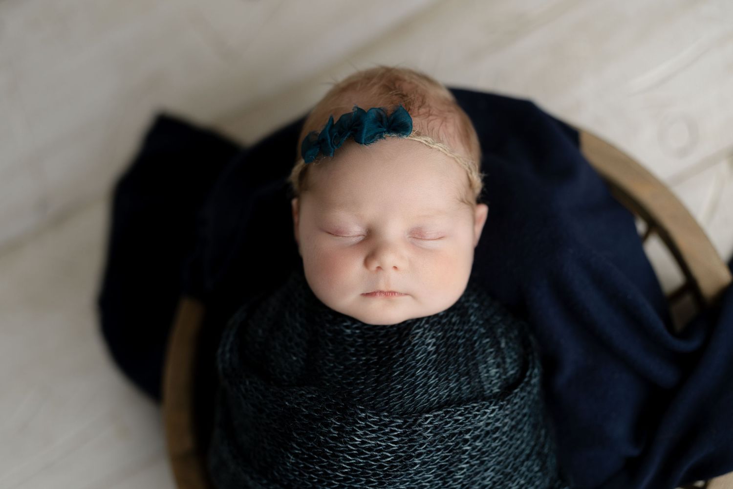 Baby wrapped in Navy knit wrap. Hatched Newborns. Madison, Mount Horeb, Verona, Middleton, Wisconsin.