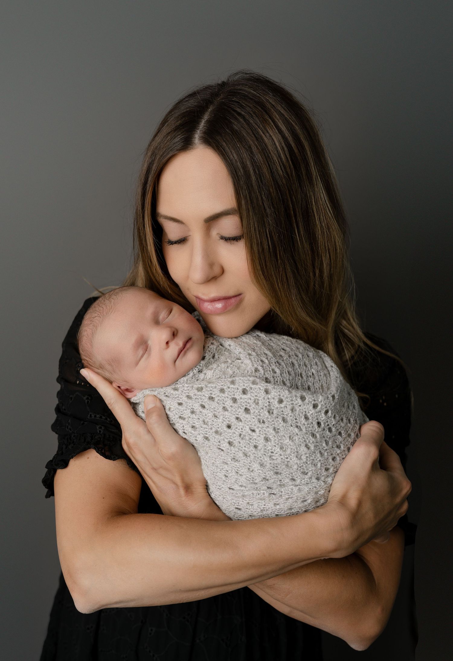 Mother snuggling her infant. Newborn photo. Hatched Newborns. Madison, Mount Horeb, Verona, Middleton, Wisconsin.