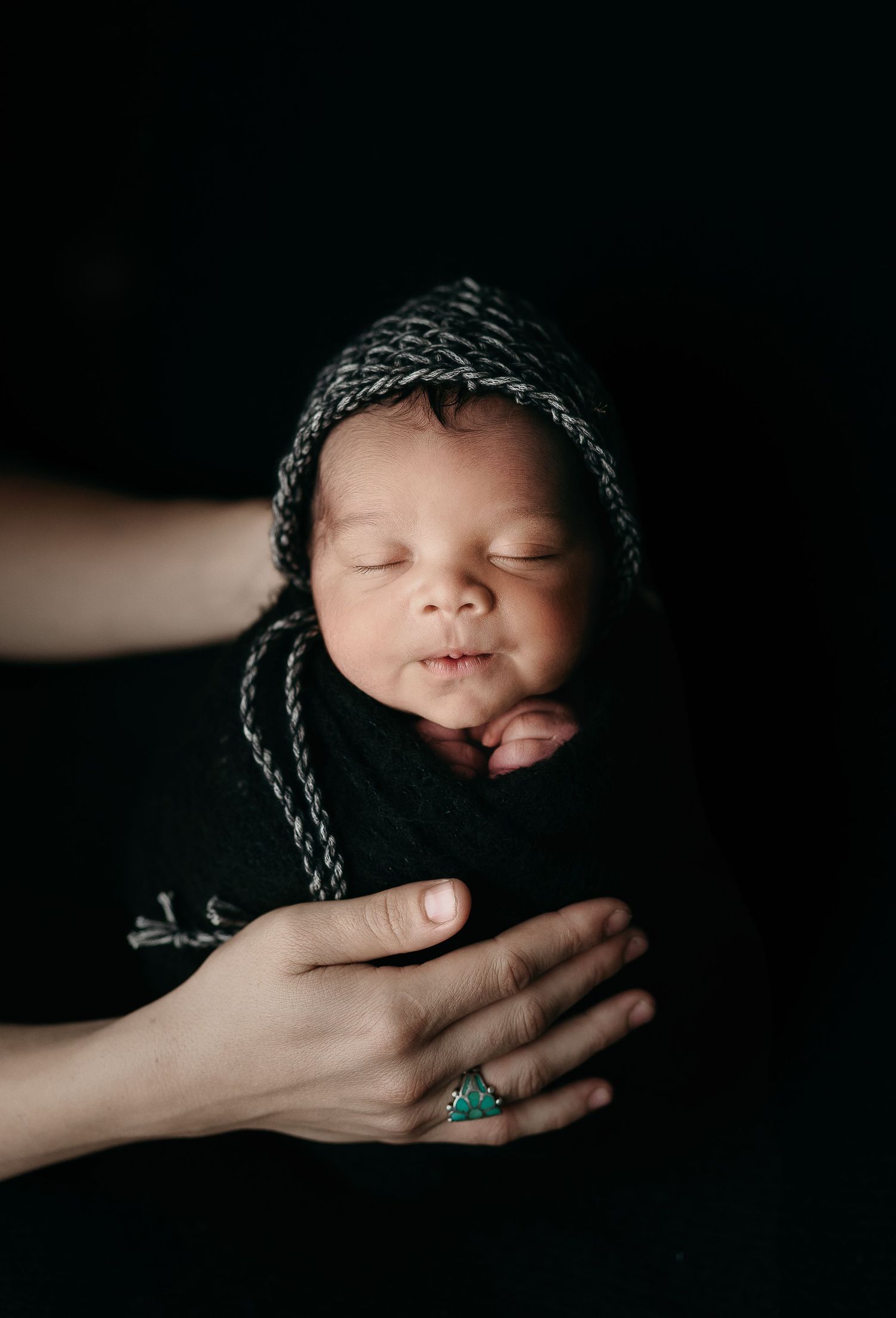 Dramatic black backdrop showcasing a cute baby. Maternity Photography by Hatched Photography, Serving Madison, Verona, Mount Horeb,