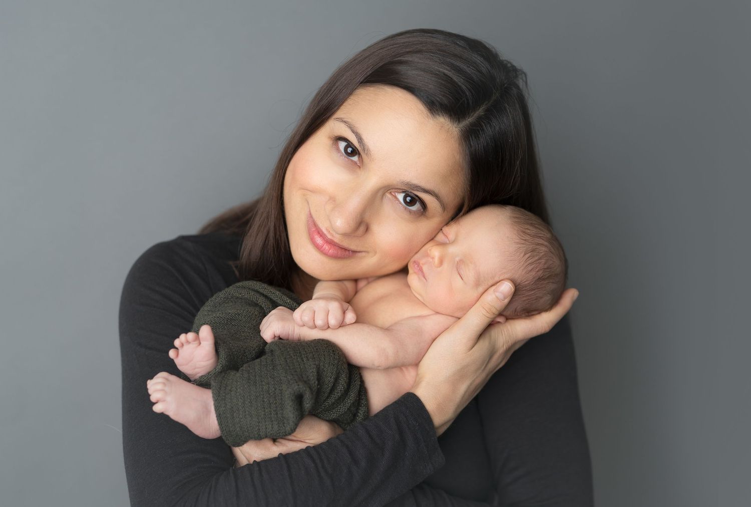 Newborn snuggled in mother's arms. Family newborn photos. Hatched newborn photography. Wisconsin's premiere newborn photography.